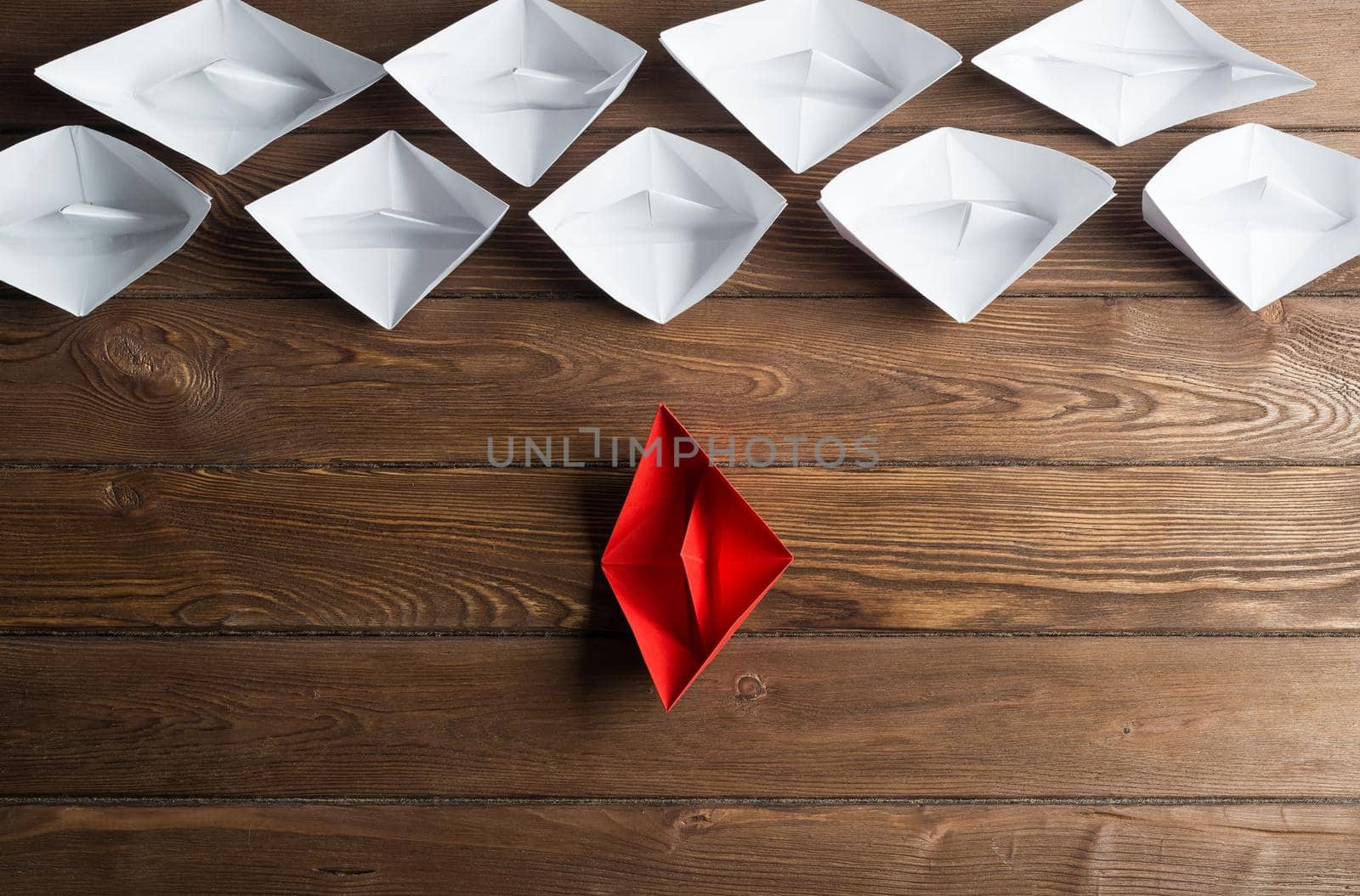 Set of origami boats on wooden table