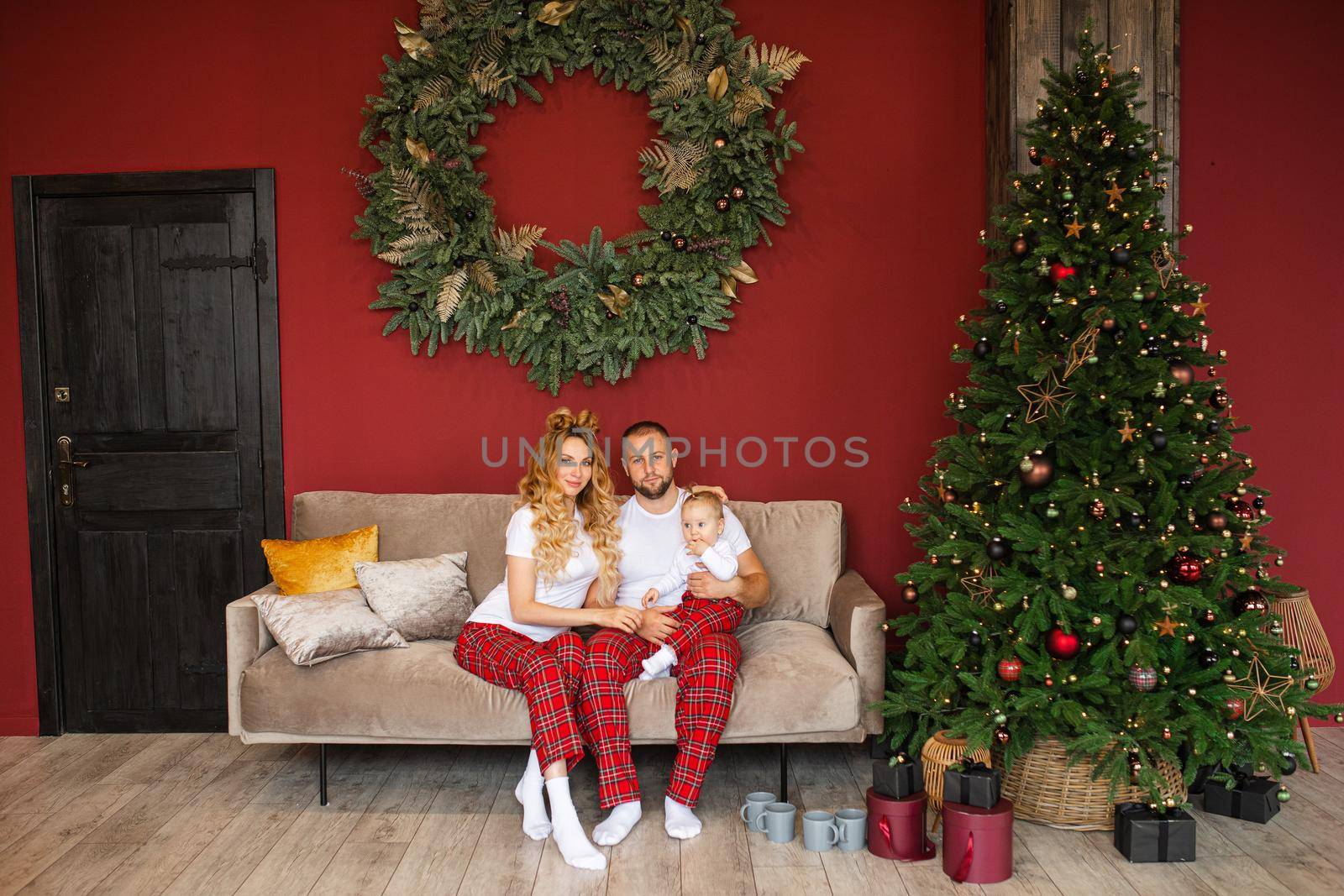 Caucasian woman and man relaxes on the sofa in the living room together in christmas atmosphere