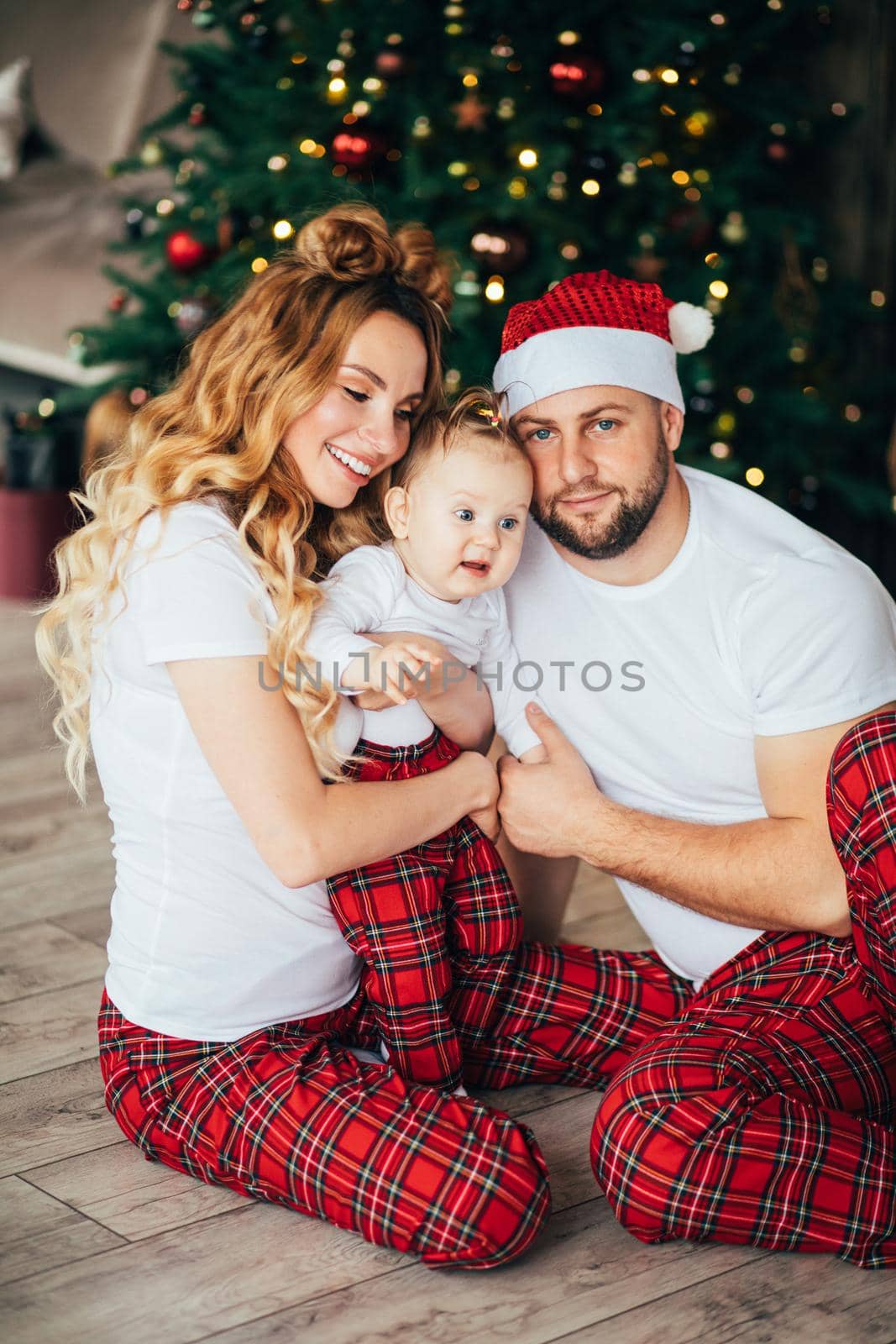 Happy family in the same sleepwear Christmas time. by StudioLucky
