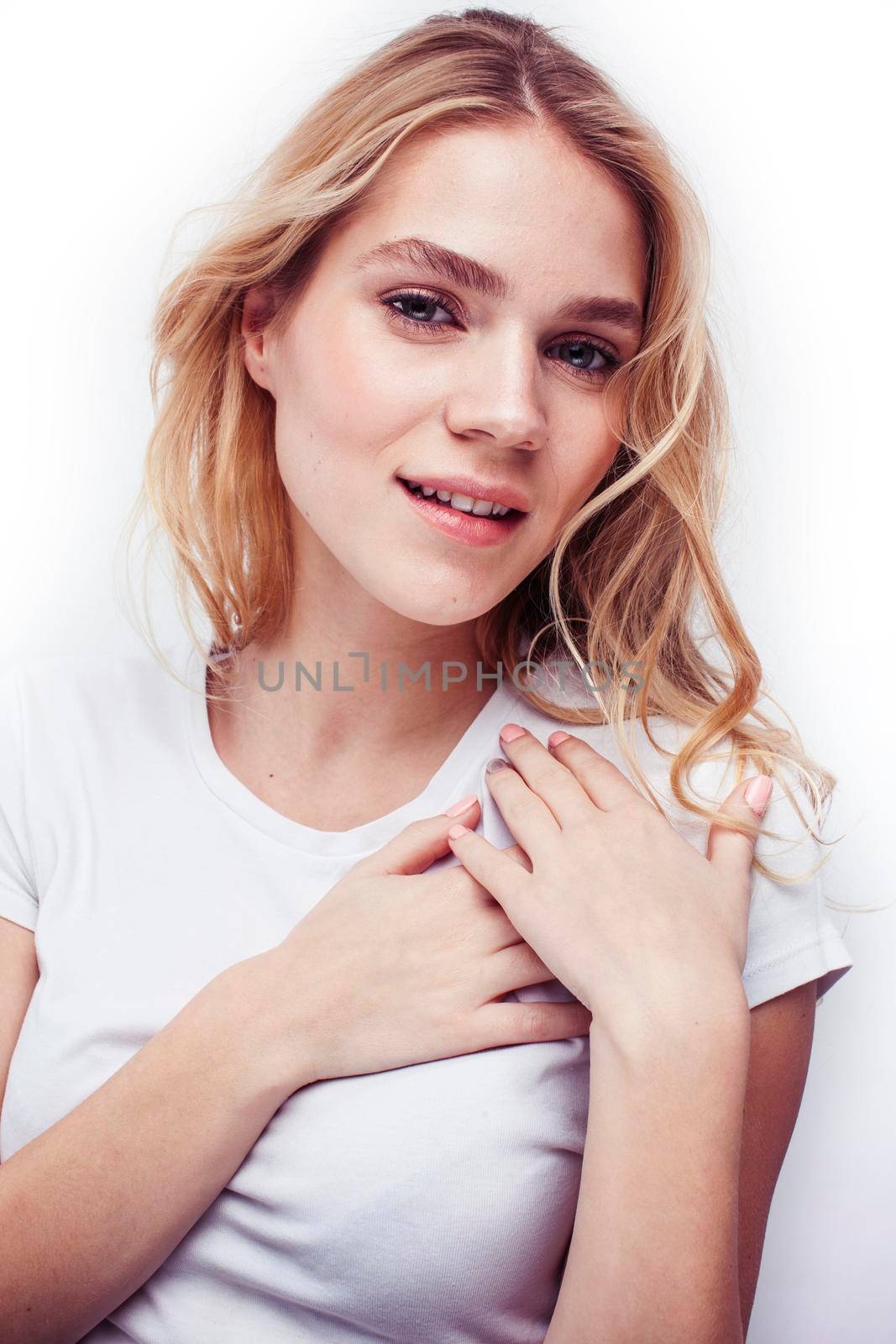 young pretty stylish blond hipster girl posing emotional isolated on white background happy smiling cool smile, lifestyle people concept close up