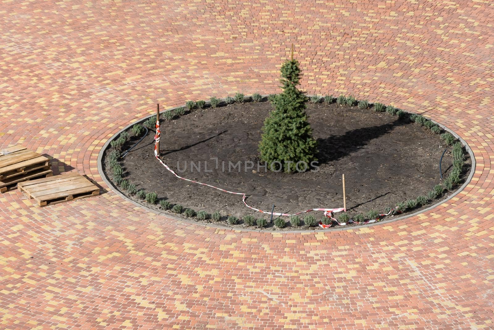 Improvement of the courtyard paving slabs, unfinished work on laying paving slabs. Laid new paving slabs sprinkled with sand and heaps of figured tiles ready for installation by Andelov13