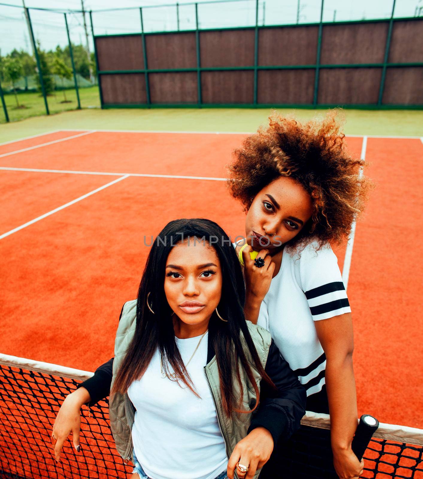 young pretty girlfriends hanging on tennis court, fashion stylish dressed swag, best friends happy smiling together lifestyle by JordanJ