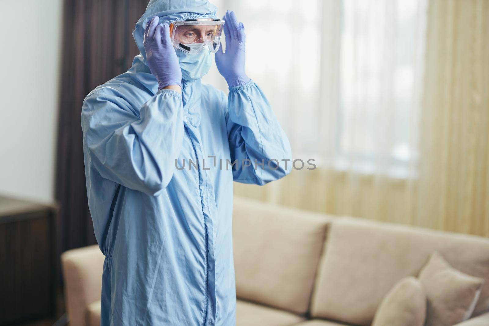 Side view of worker making disinfection in hotel room from viruses and coronavirus. Coronavirus and quarantine concept