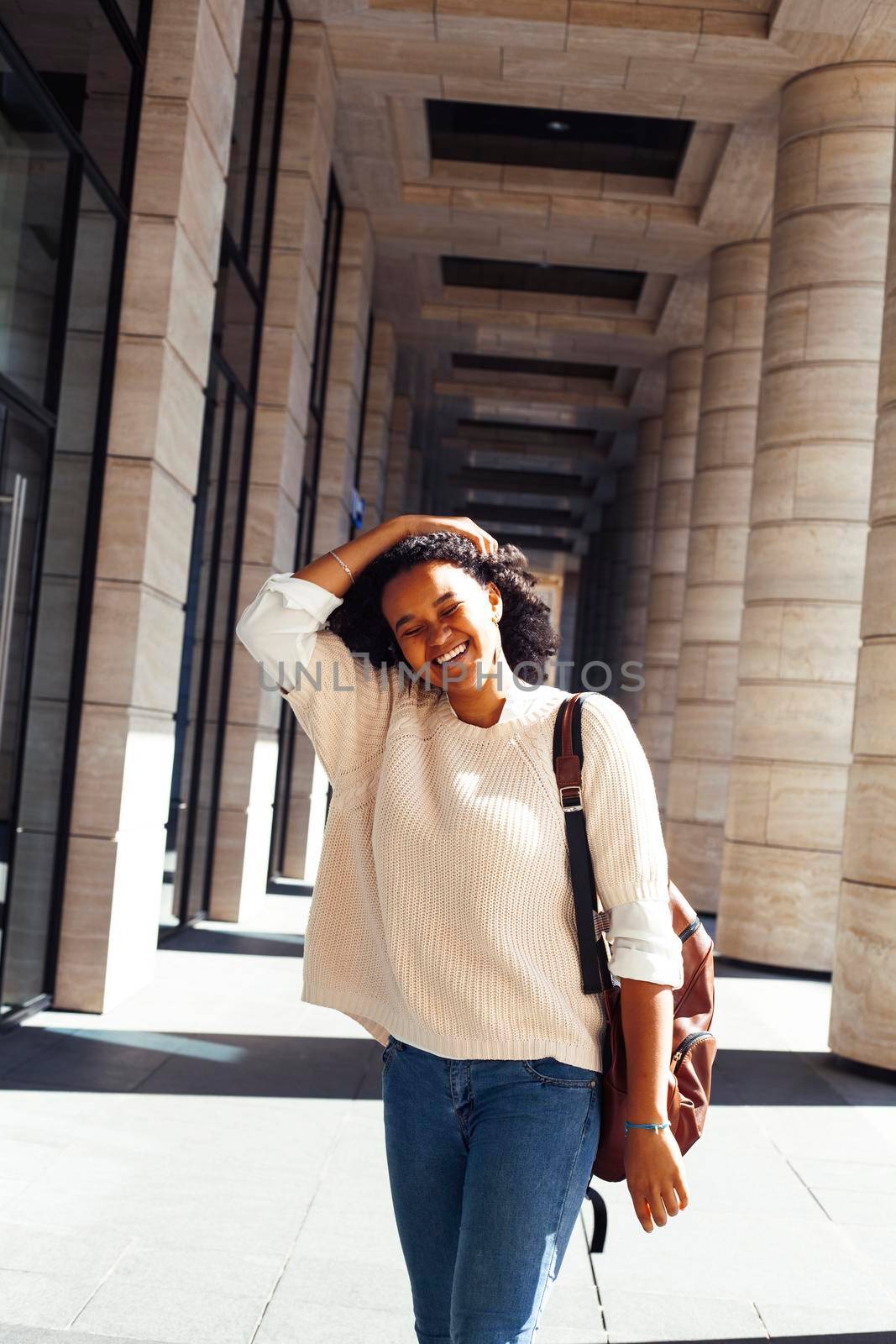 young pretty african girl posing cheerful on city background, lifestyle outdoor people concept close up