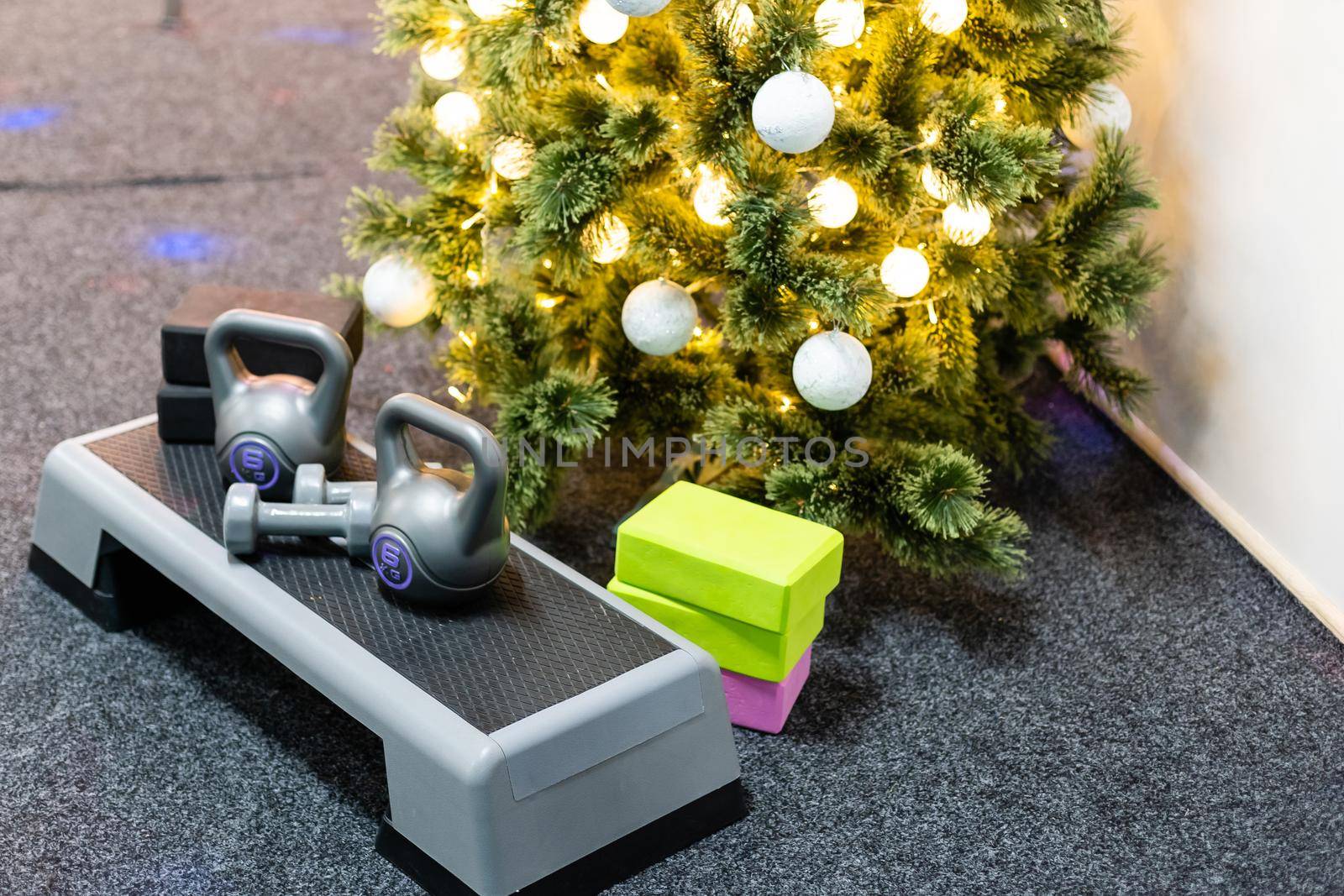 Christmas sports. Black sport step, kettlebell, yoga blocks. Merry christmas and Happy new year wish sport gifts greeting card concept top view with copy space.