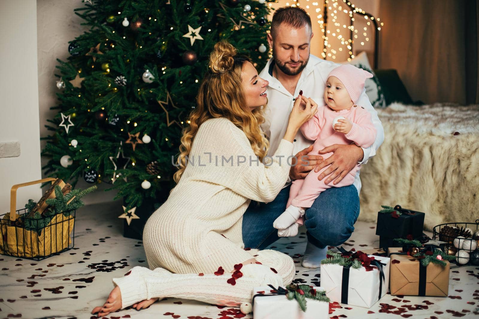 Happy young family going to celebrate Christmas together in their cosy home. Holiday concept