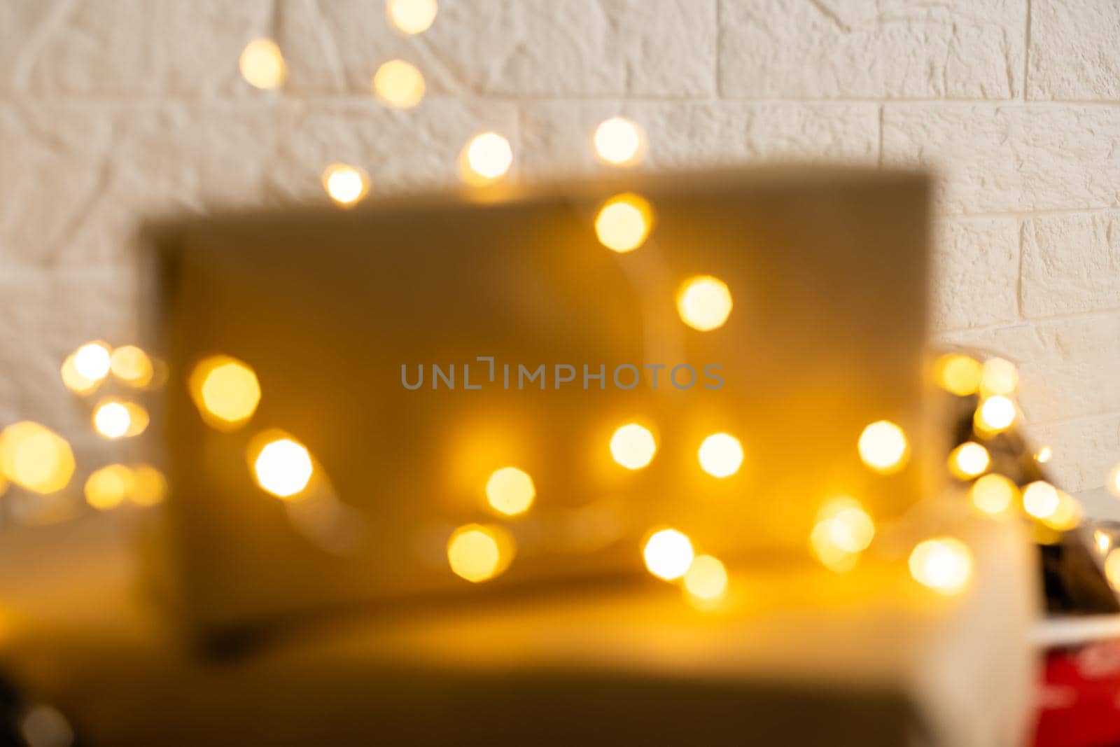 Blurred background. Bright glowing yellow-orange New Year, Christmas garland out of focus.