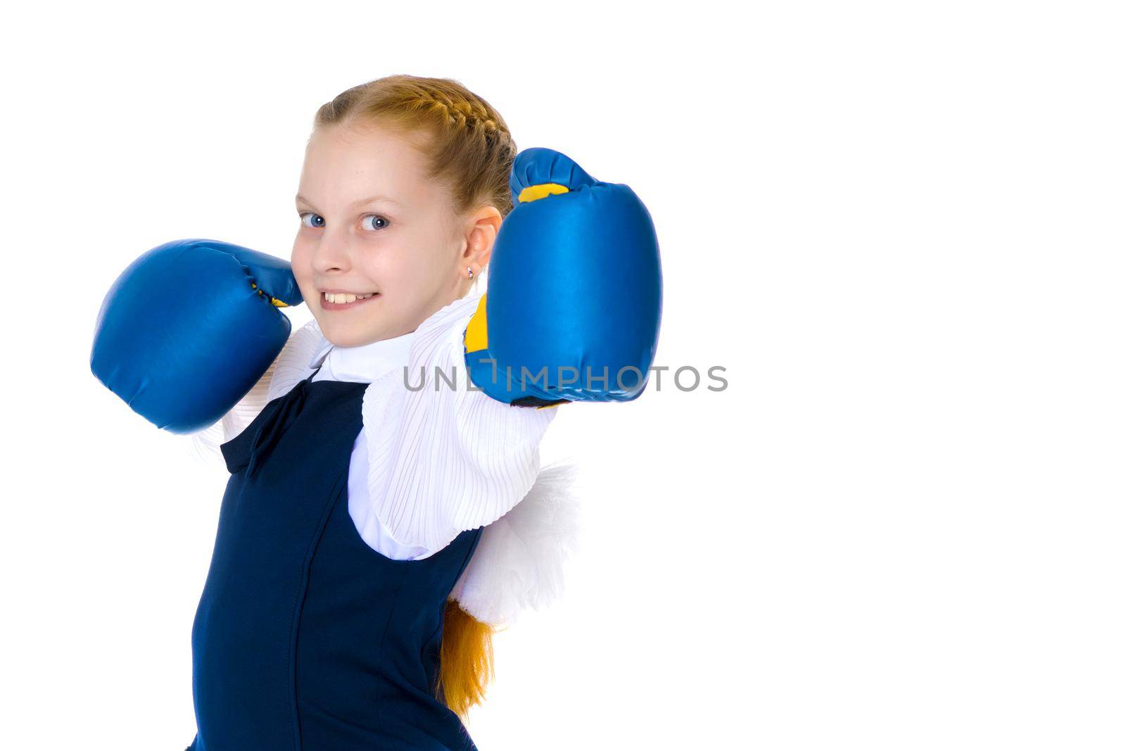 A cheerful little girl in boxing gloves. The concept of sport, children's emotions. Isolated on white background.