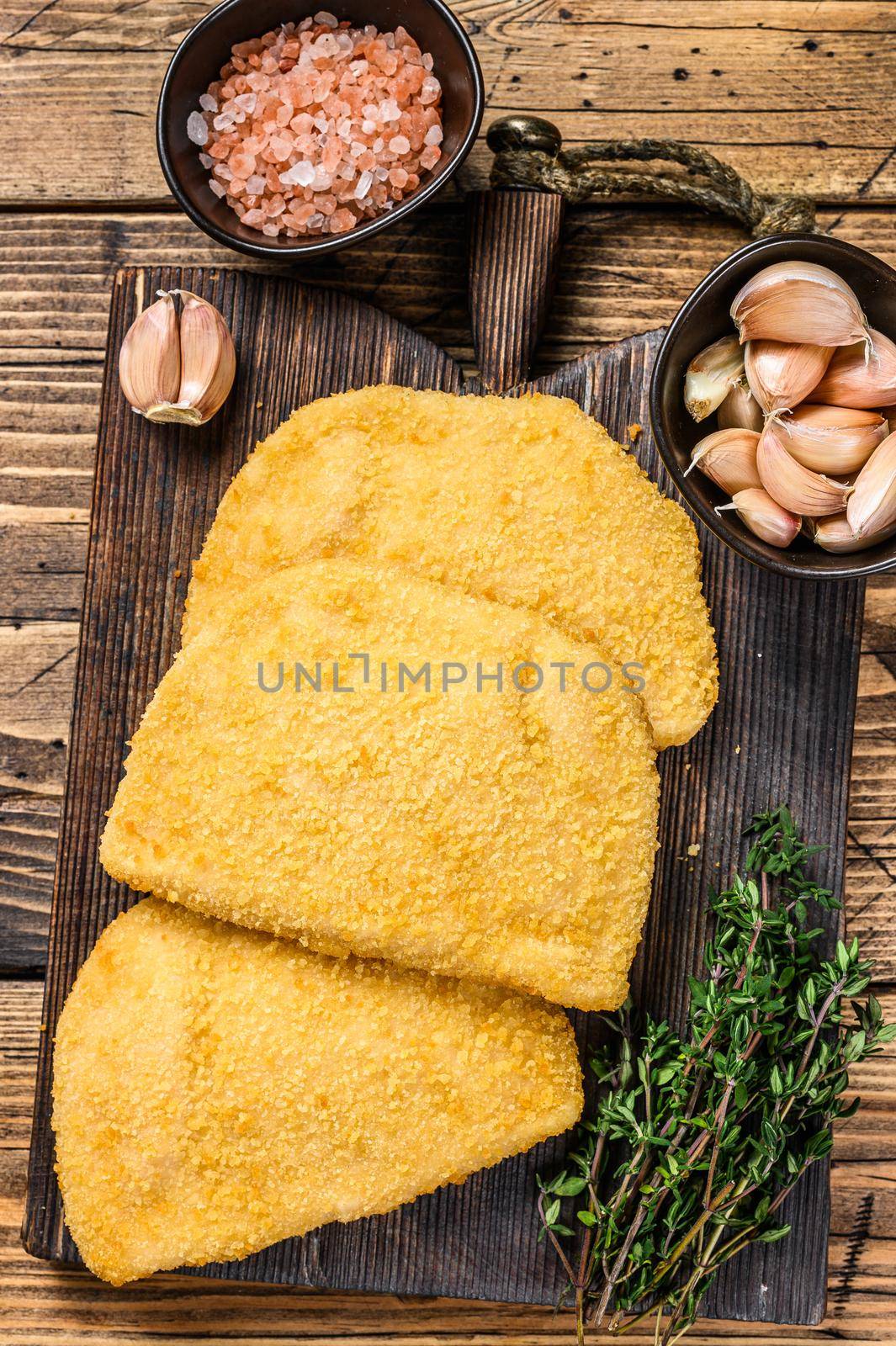 Cordon bleu meat cutlets with bread crumbs on a wooden board. wooden background. Top view.