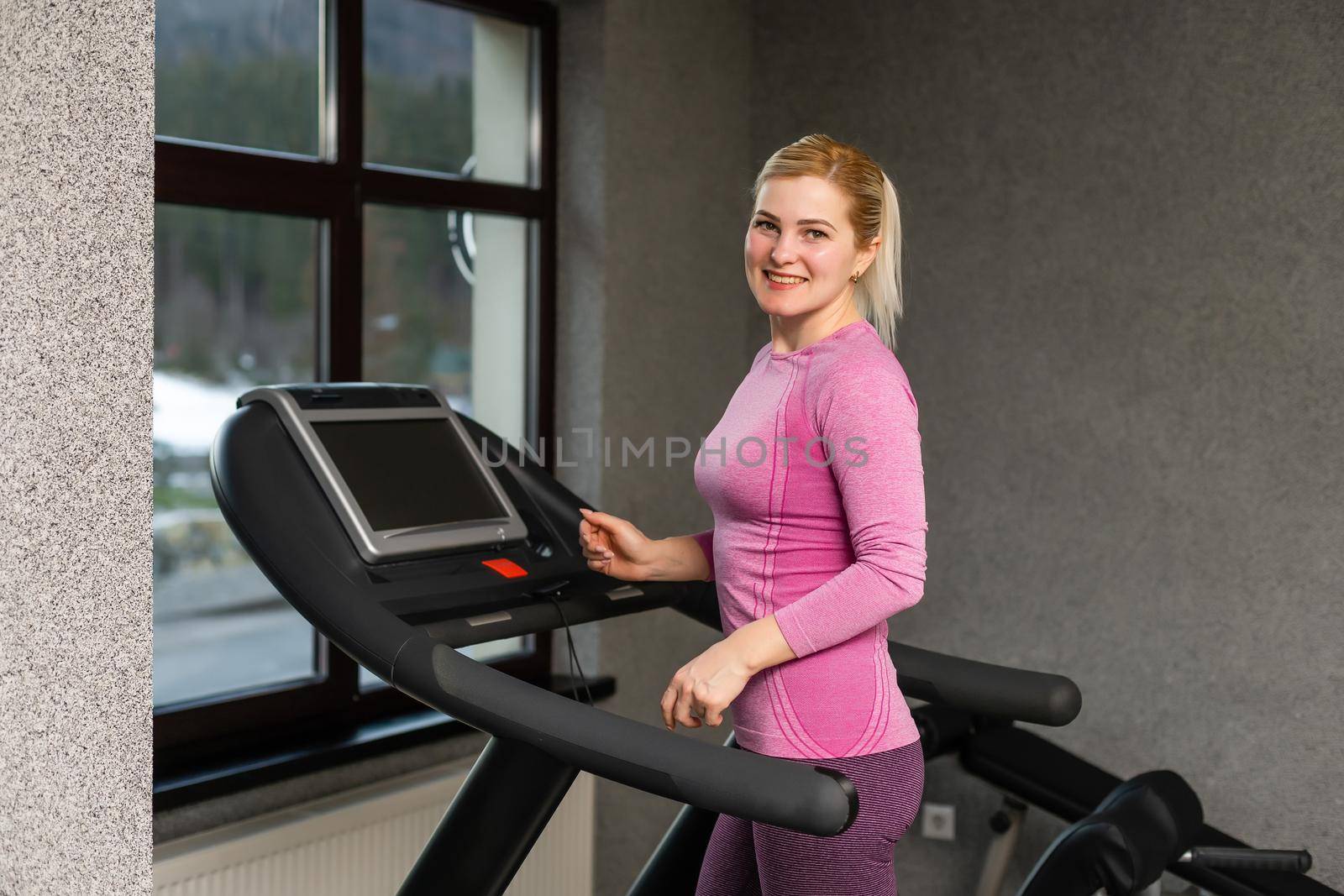 The young girl on a racetrack, woman on treadmill
