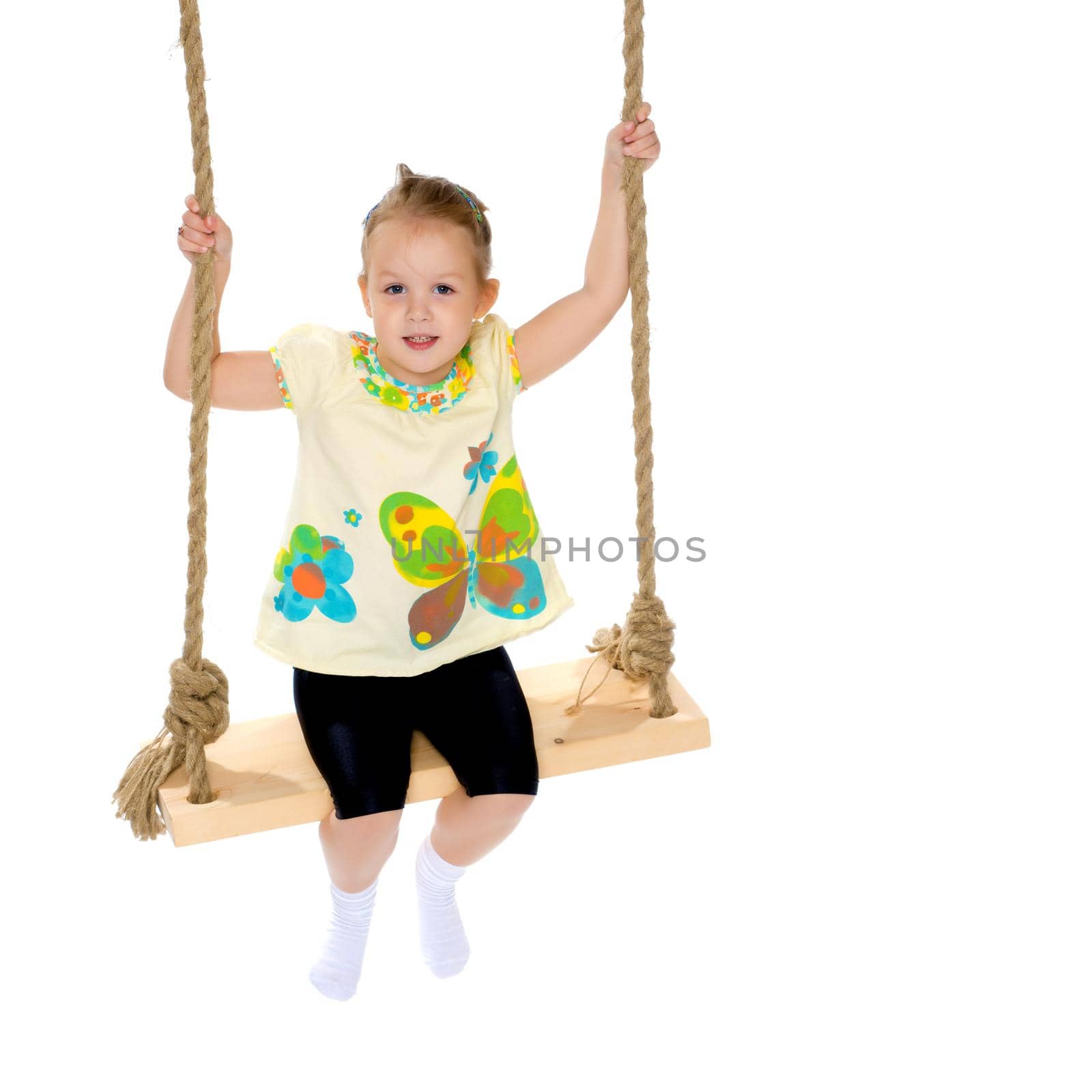 Beautiful little girl swinging on swing. The concept of family happiness, child development, sports education and summer recreation. Isolated on white background.