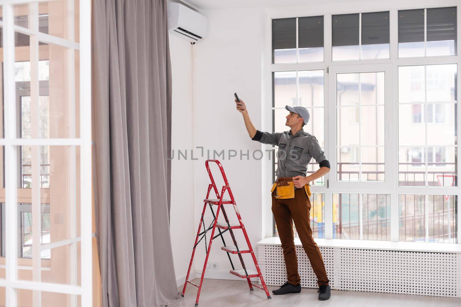 Service personnel are working in a room of the house.