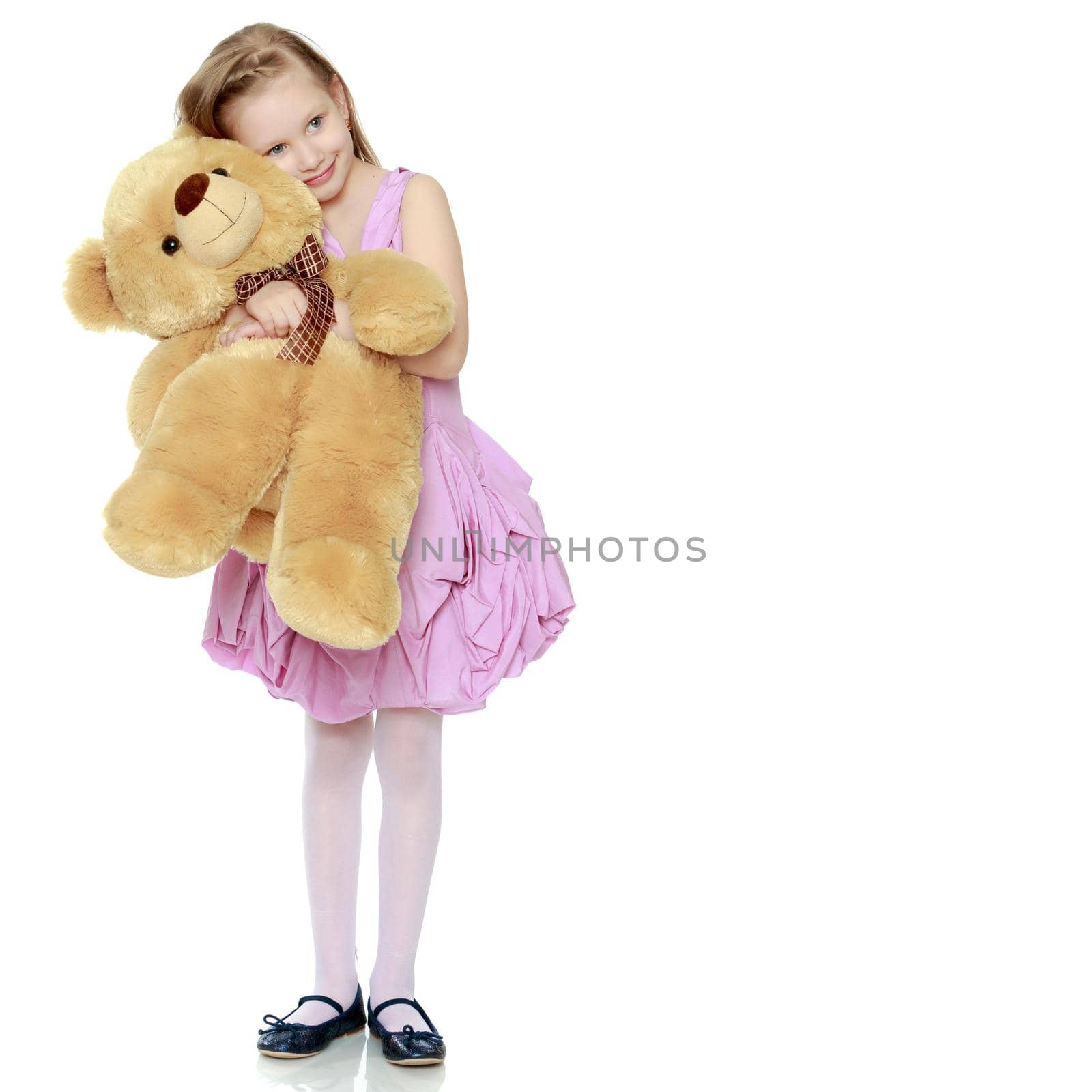 Beautiful little girl 5-6 years.She is holding a large teddy bea by kolesnikov_studio