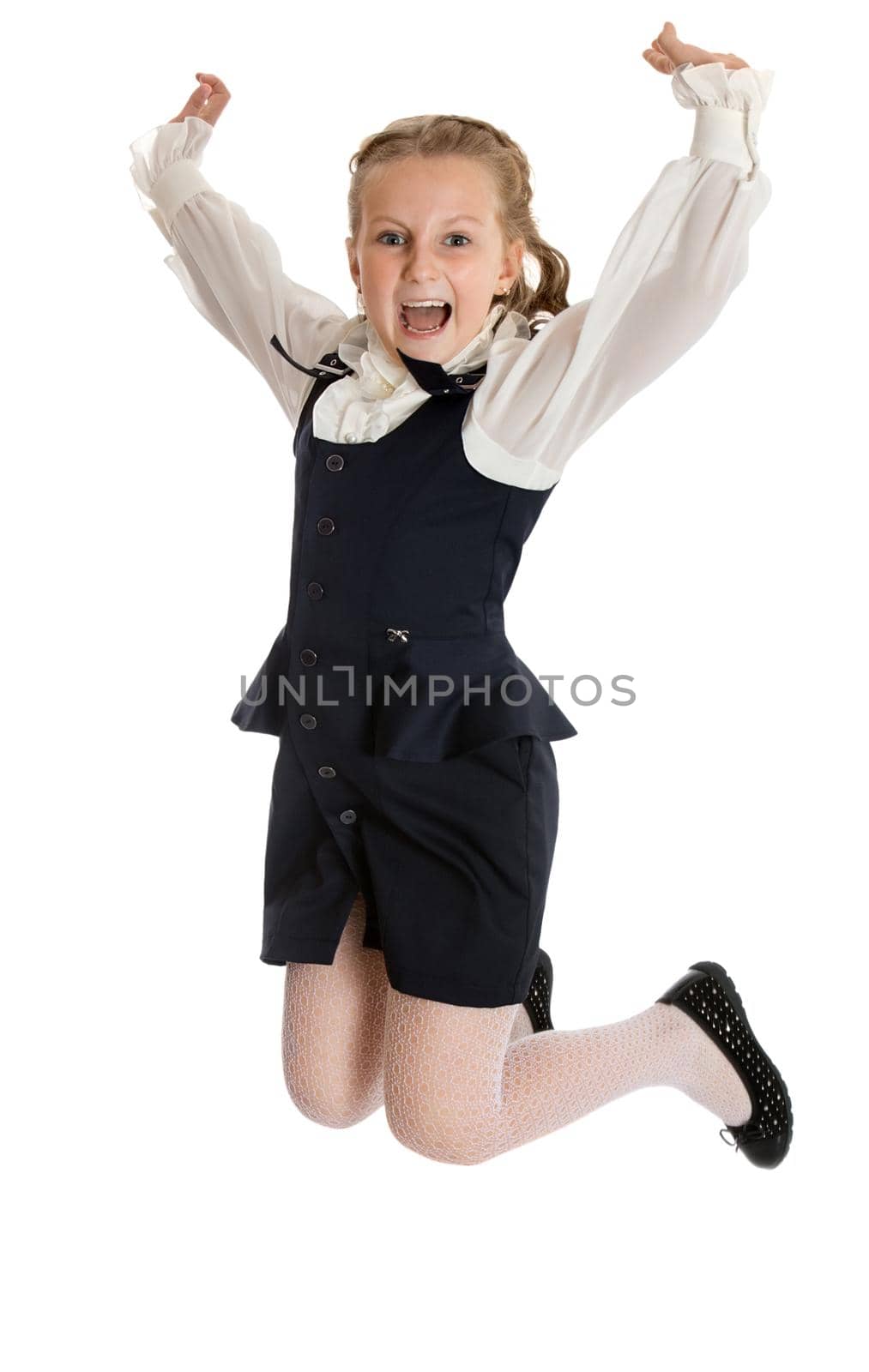 Stylish little girl in a black suit. Girl jumping raising his hands up - Isolated on white background