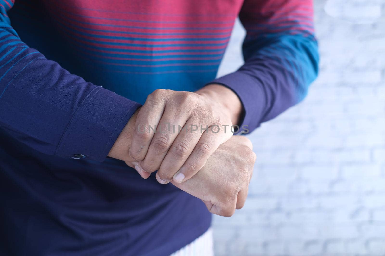 man suffering pain in hand close up .