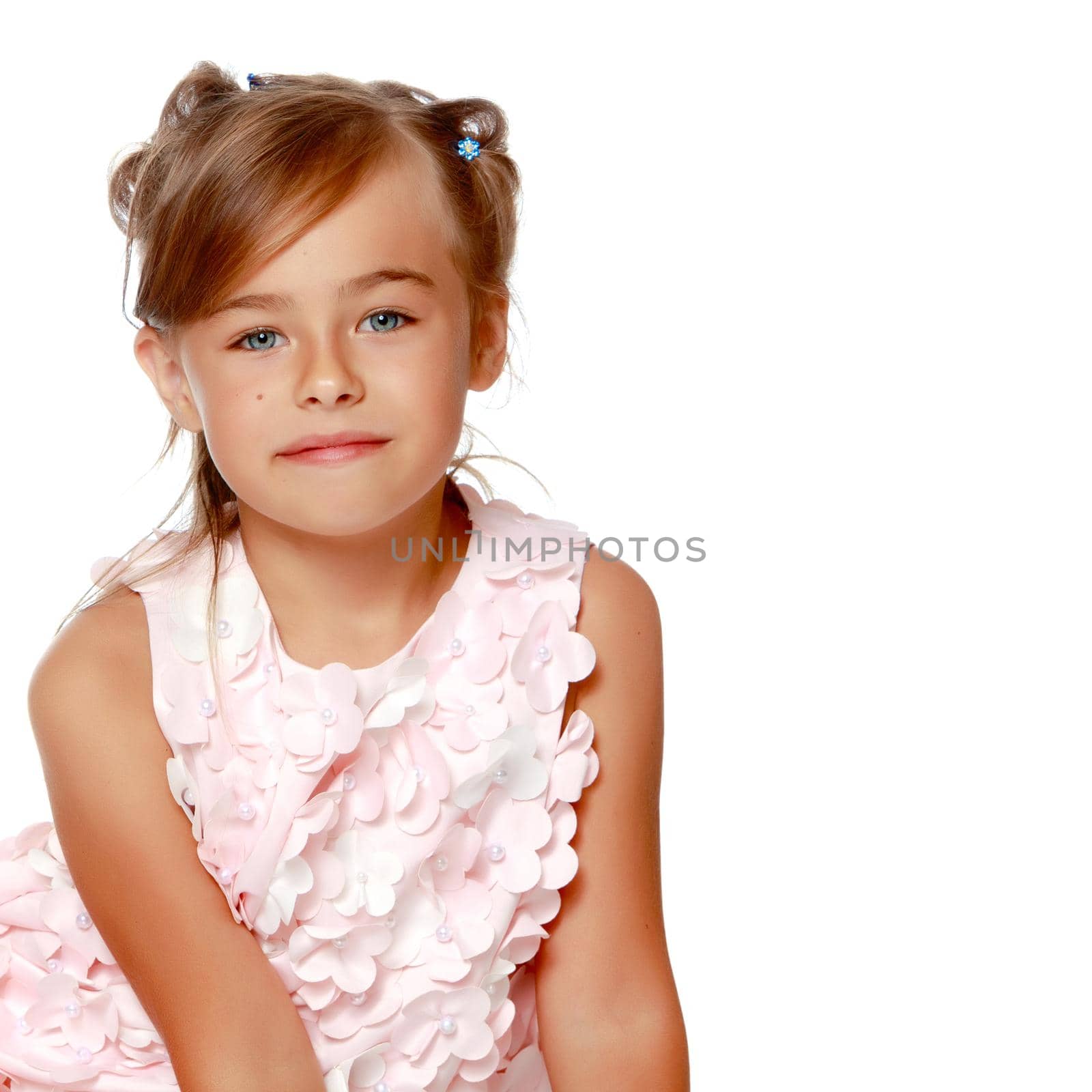 Studio portrait of a beautiful little girl. The concept of fashion, family happiness, harmonious development of the child. Isolated on white background.