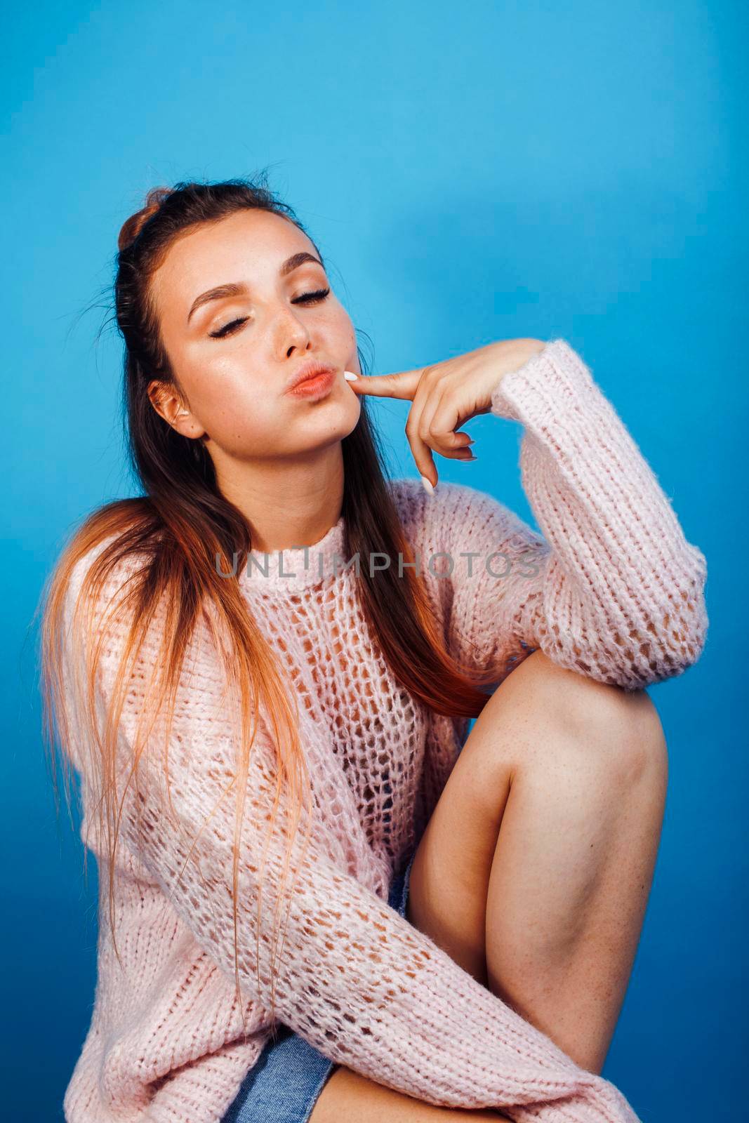 young pretty modern hipster girl posing emotional happy on blue background, lifestyle people concept by JordanJ