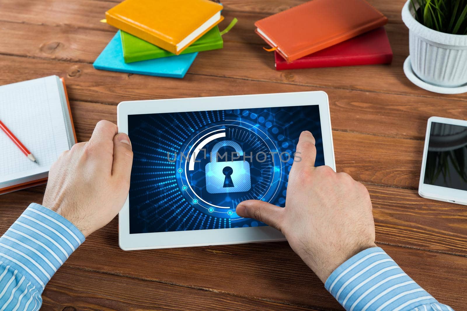 close-up, male hands with tablet. Businessman working at the table in office. computer security concept