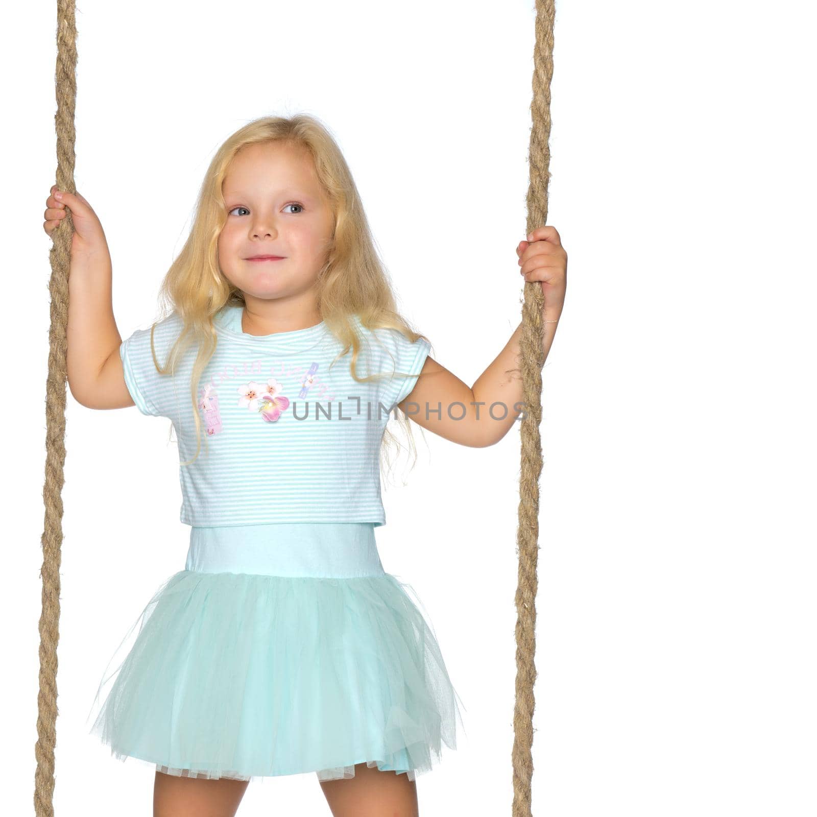 Beautiful little girl swinging on a swing. The concept of family happiness, summer holidays. Isolated on white background.