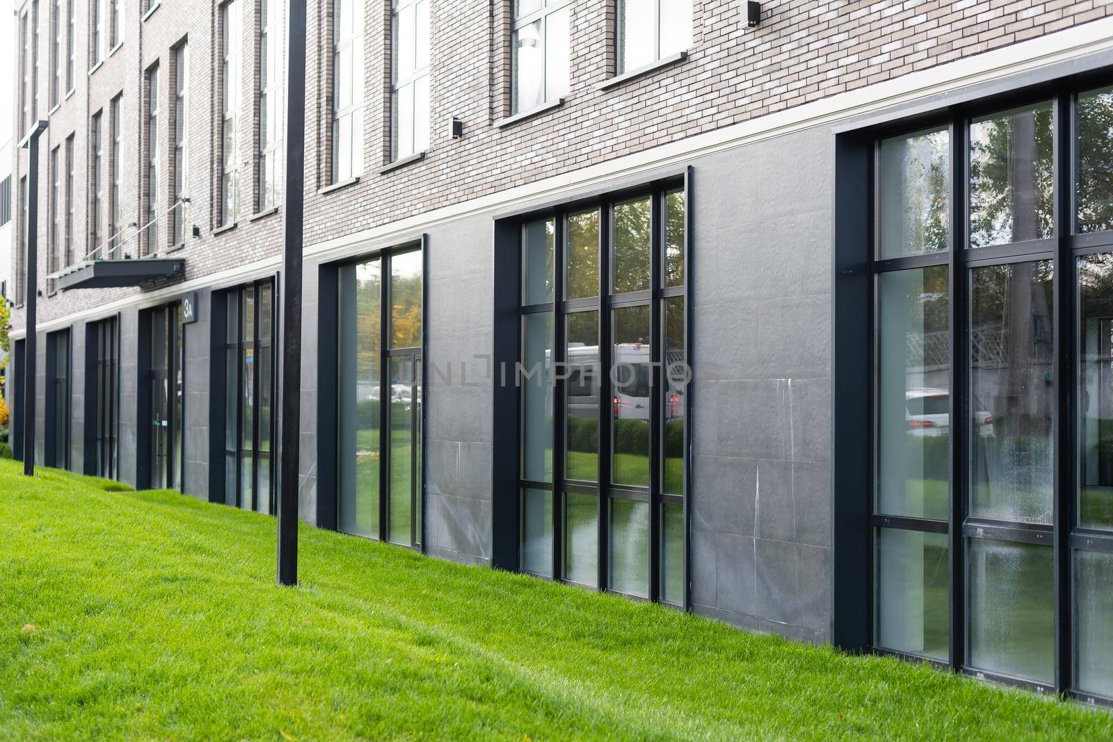 green landscaping near the facade of a business building.