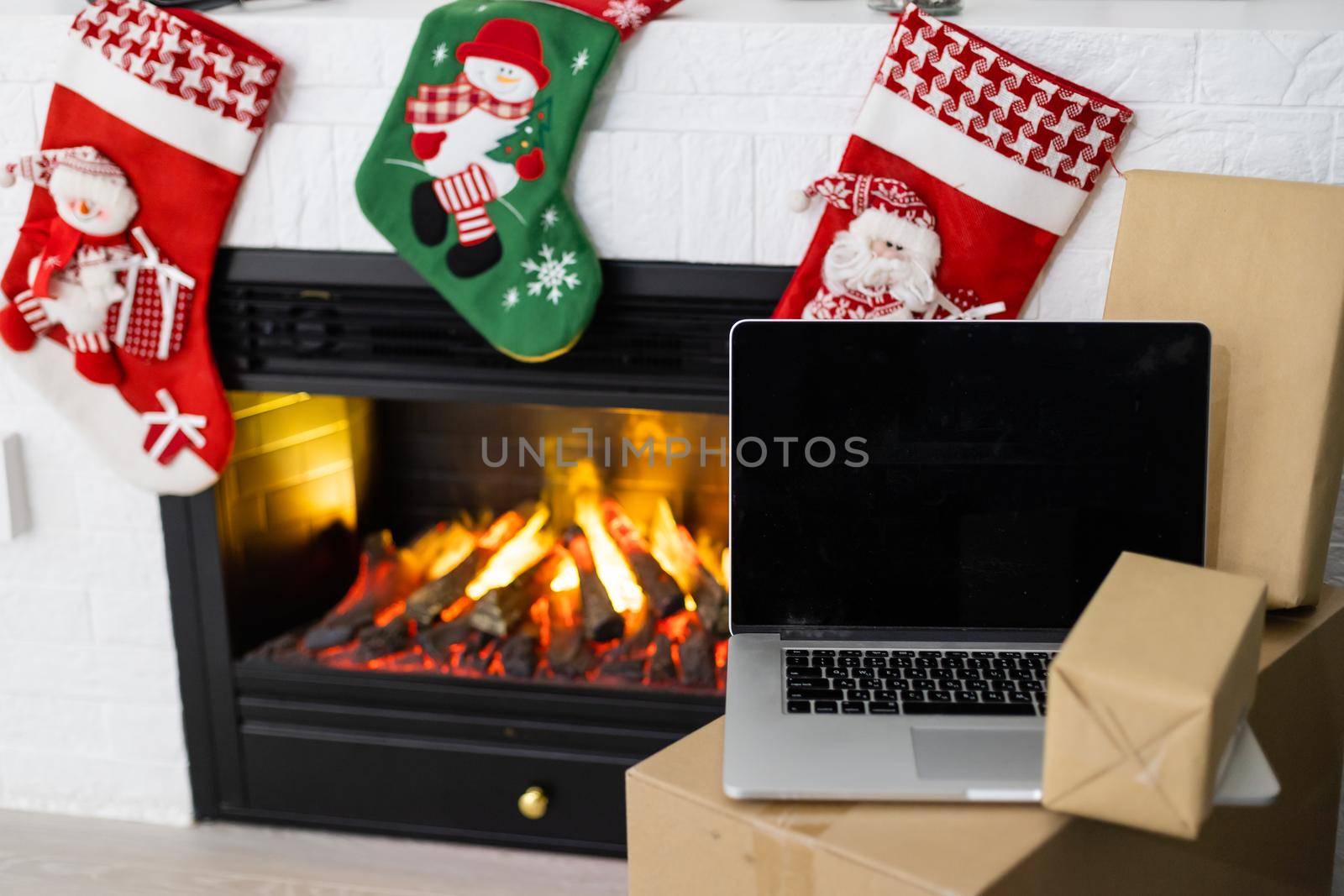 delivery christmas gifts. delivery boxes near fireplace before christmas by Andelov13