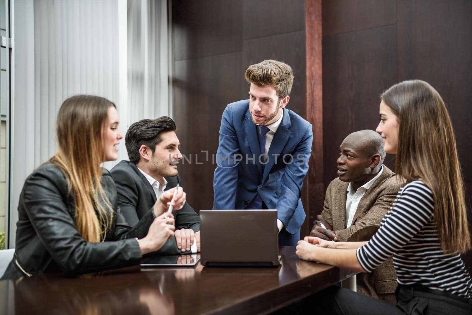 Businesspeople, teamwork. Group of multiethnic busy people working in an office