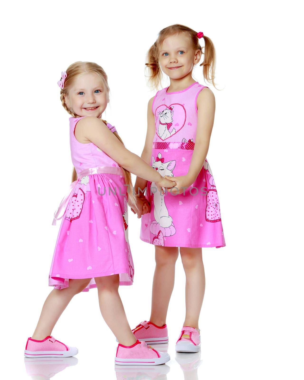 Two cute little girls in full growth by kolesnikov_studio