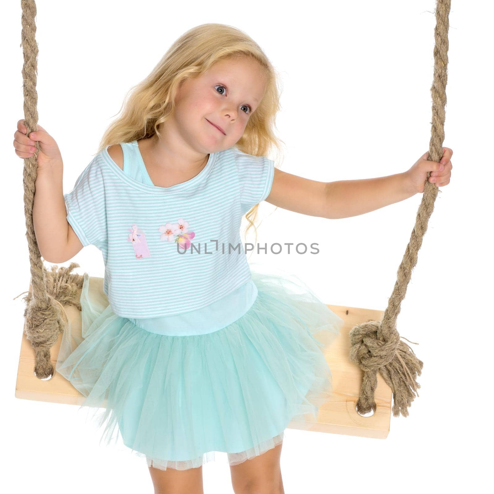 Beautiful little girl swinging on a swing. The concept of family happiness, summer holidays. Isolated on white background.