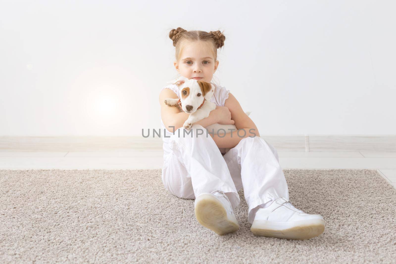 Dogs, pets and animal concept - Little child girl sitting with puppy Jack Russell Terrier by Satura86