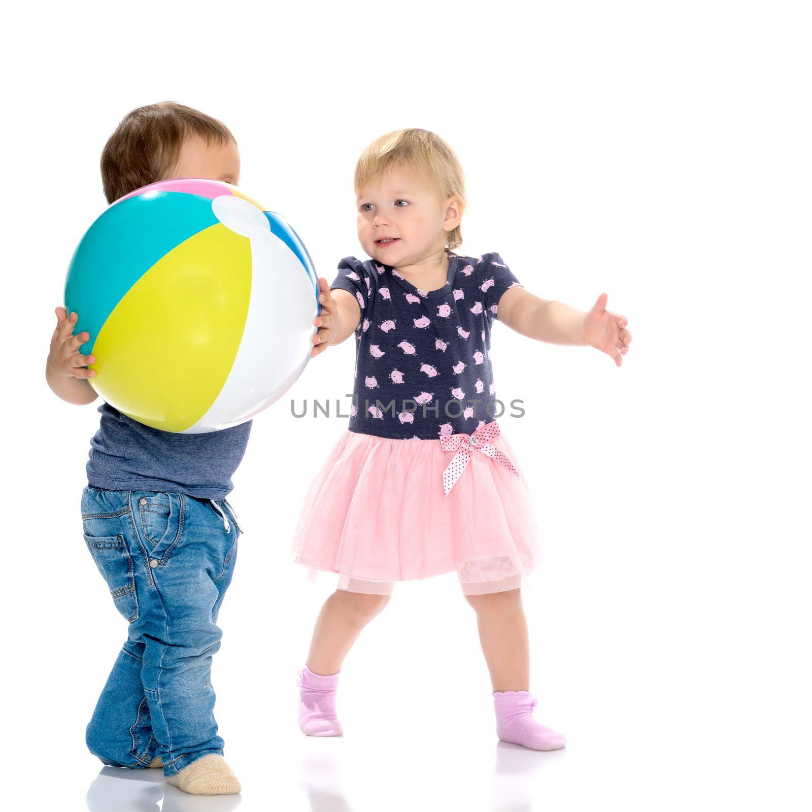 Toddler boy and girl playing with ball. The concept of a harmonious development of a child in the family, a happy childhood. Isolated on white background.