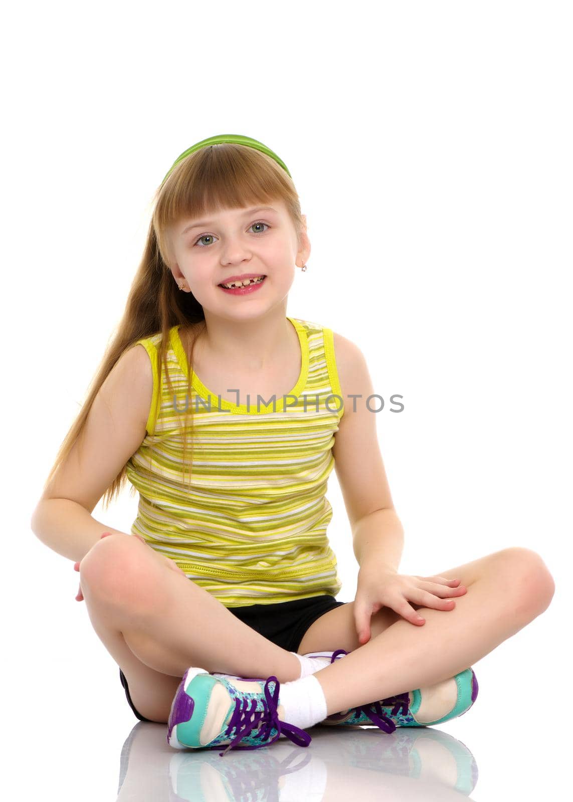 The gymnast perform an acrobatic element on the floor.A girl gymnast performs an acrobatic element on the floor. The concept of childhood, sport, healthy lifestyle. Isolated on white background.