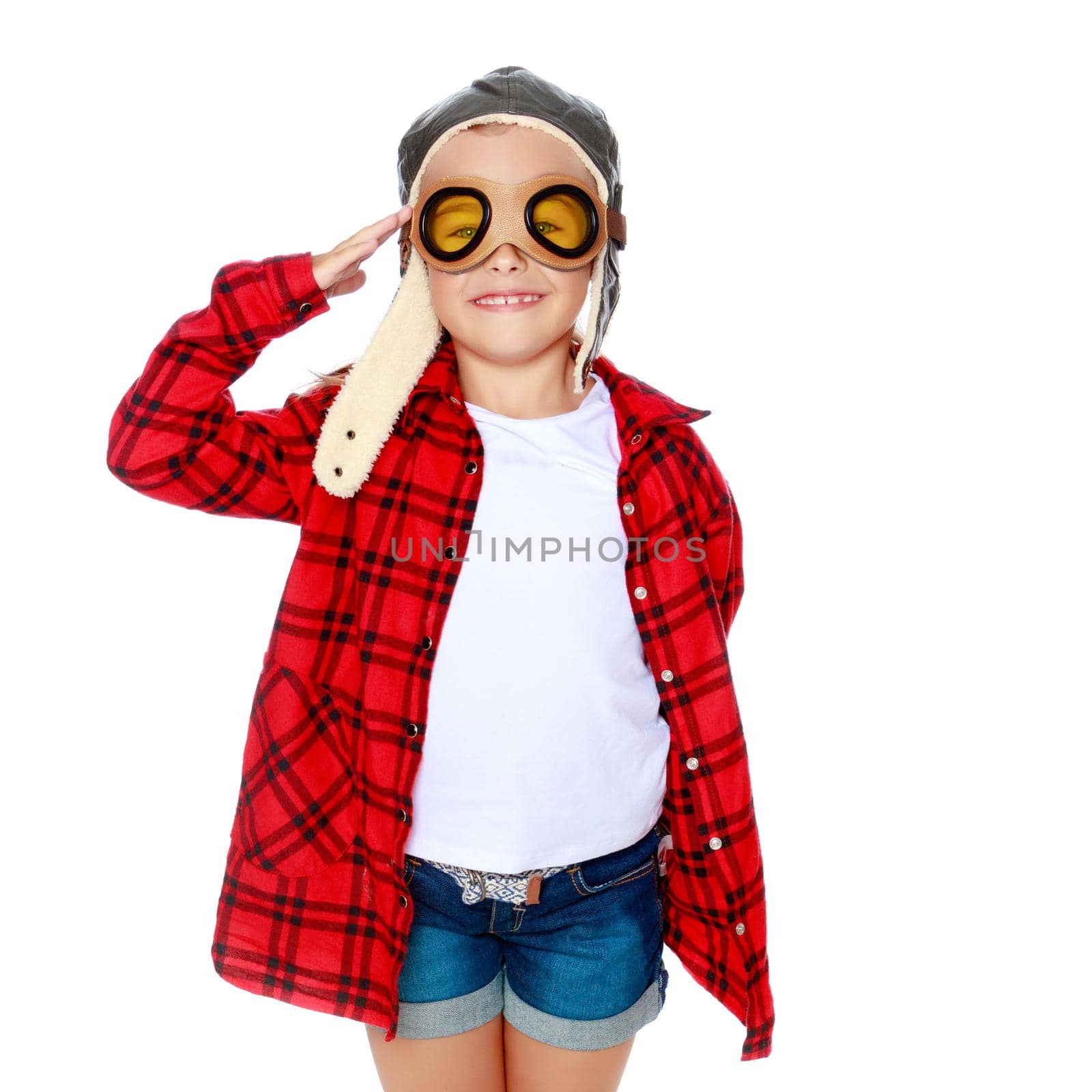 Little girl in helmet pilot with wooden plane in hand. The concept of family happiness, the embodiment of a dream, a love of travel. Isolated on white background.