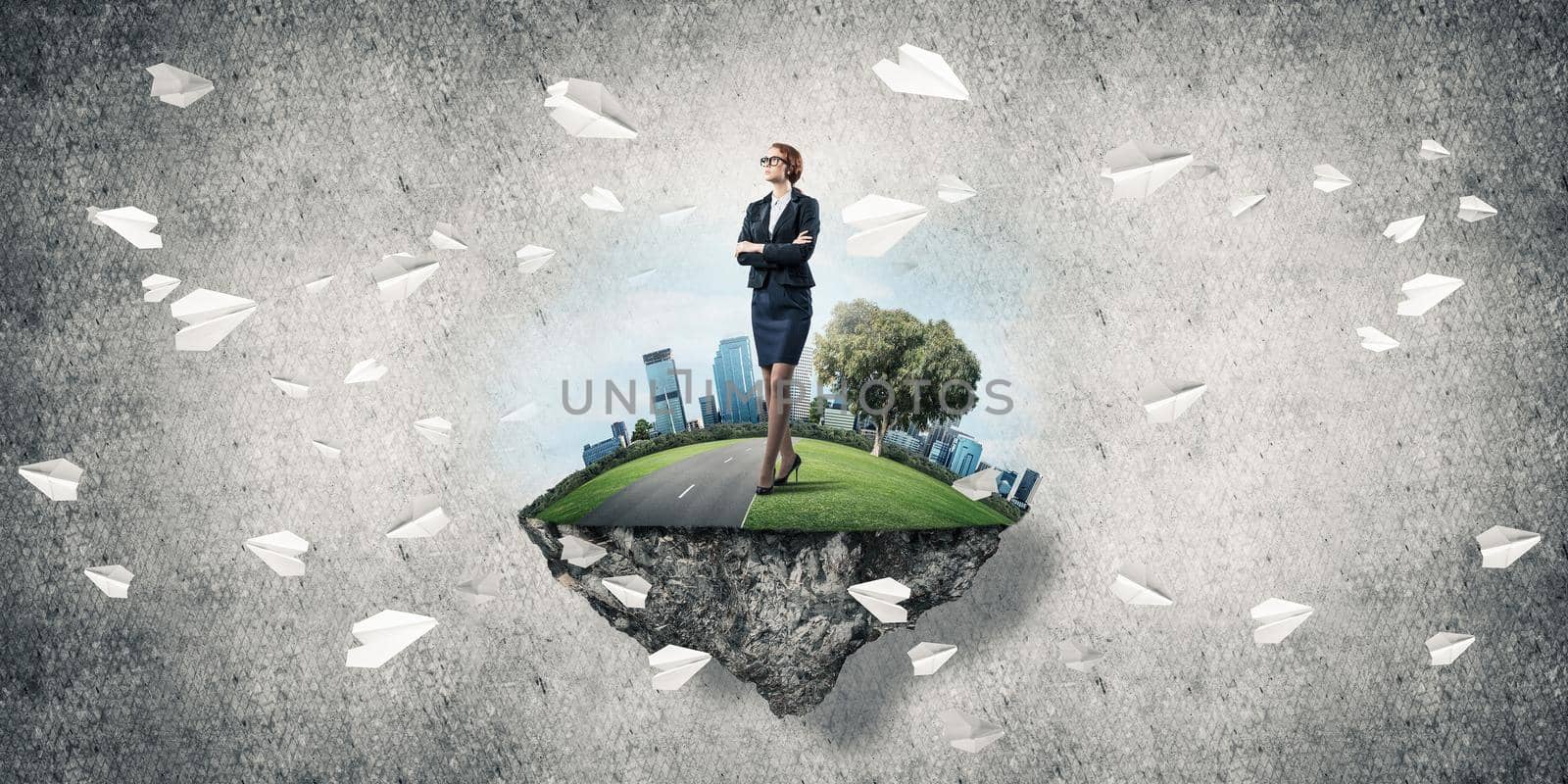 Elegant confident businesswoman standing on green floating island against concrete background