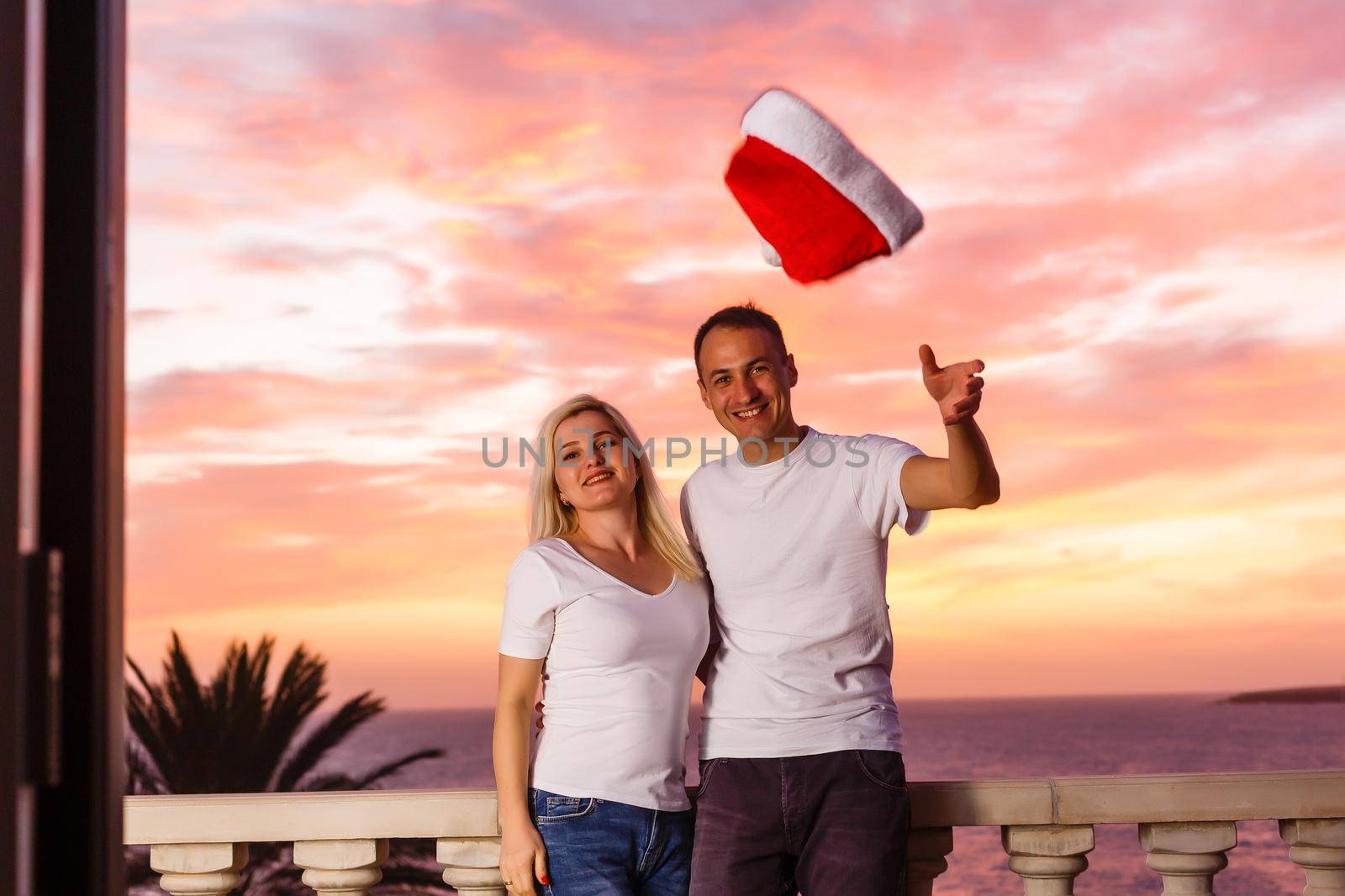 Woman admiring sunset from her balcony by Andelov13