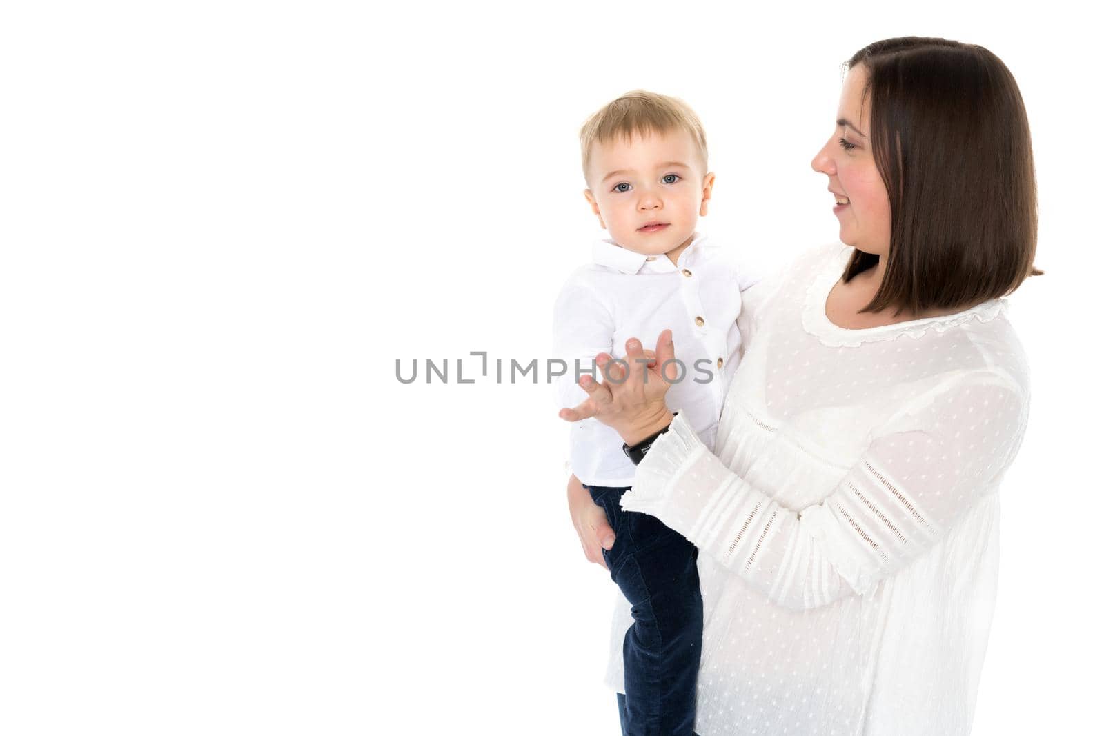 Happy smiling loving mother and her baby is playing on a white background. Mom throws the baby in her arms. Isolated.
