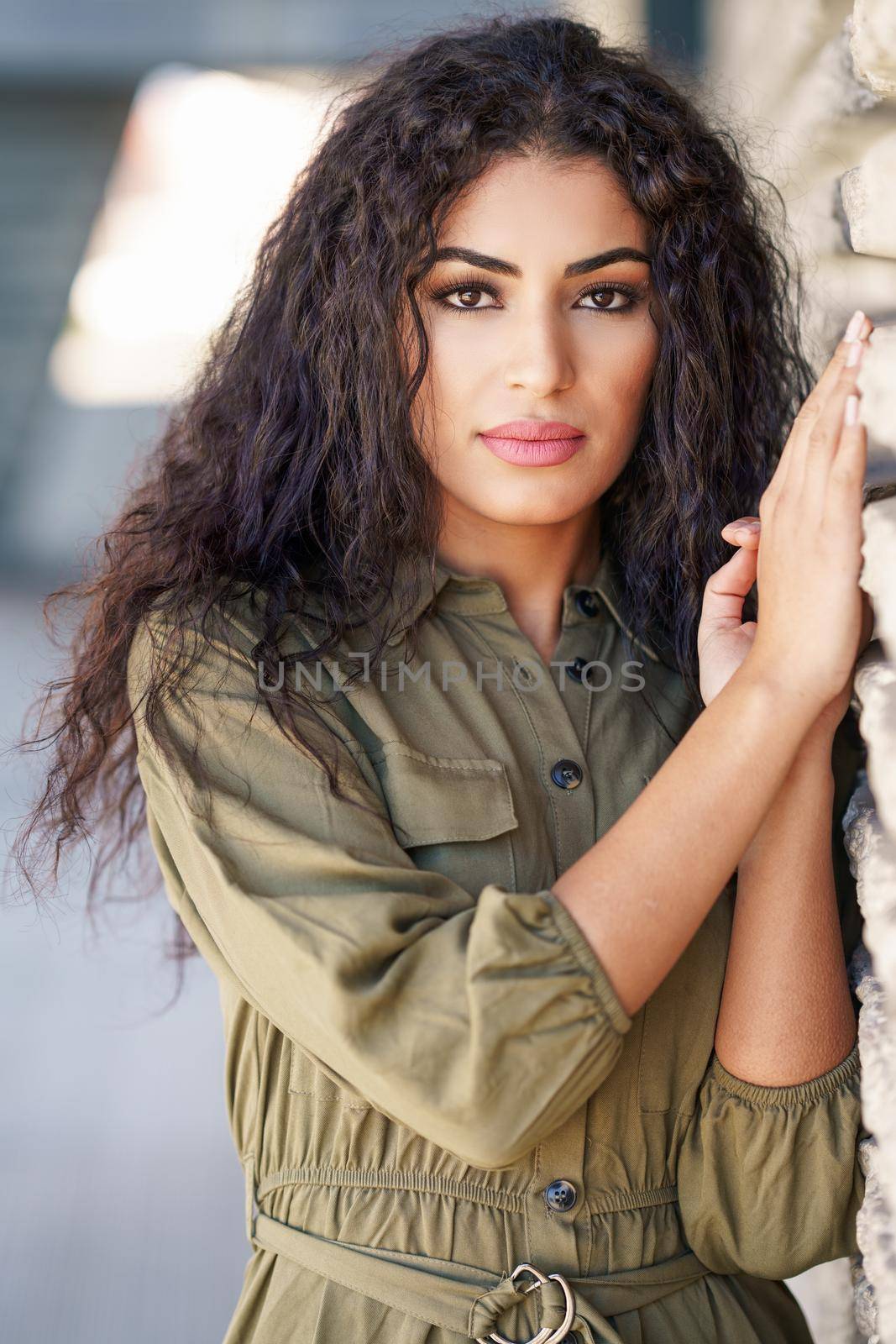 Young Arab Woman with curly hair in urban background
