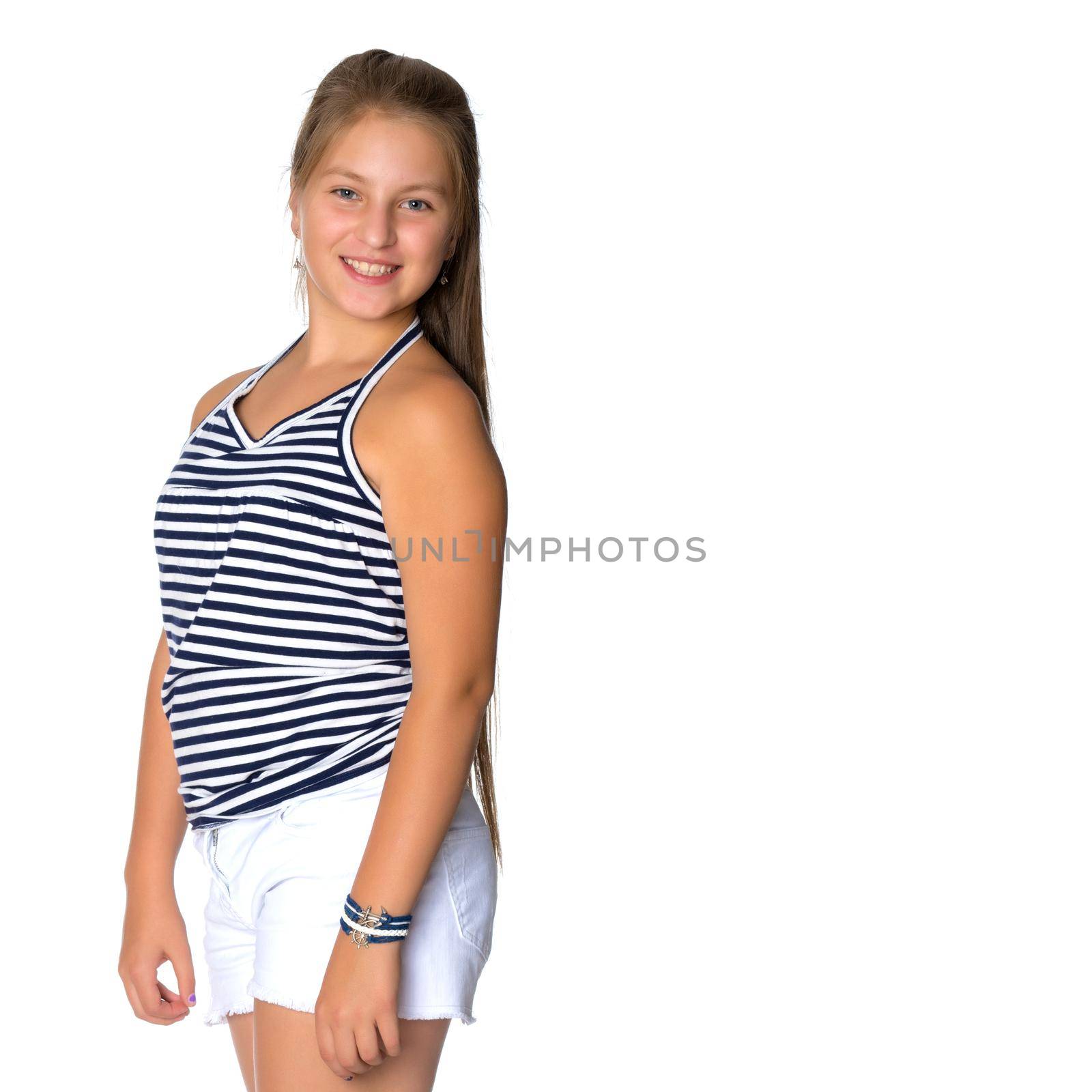 A beautiful teen girl sits on the floor on a white background. The concept of education and schoo. Isolated.