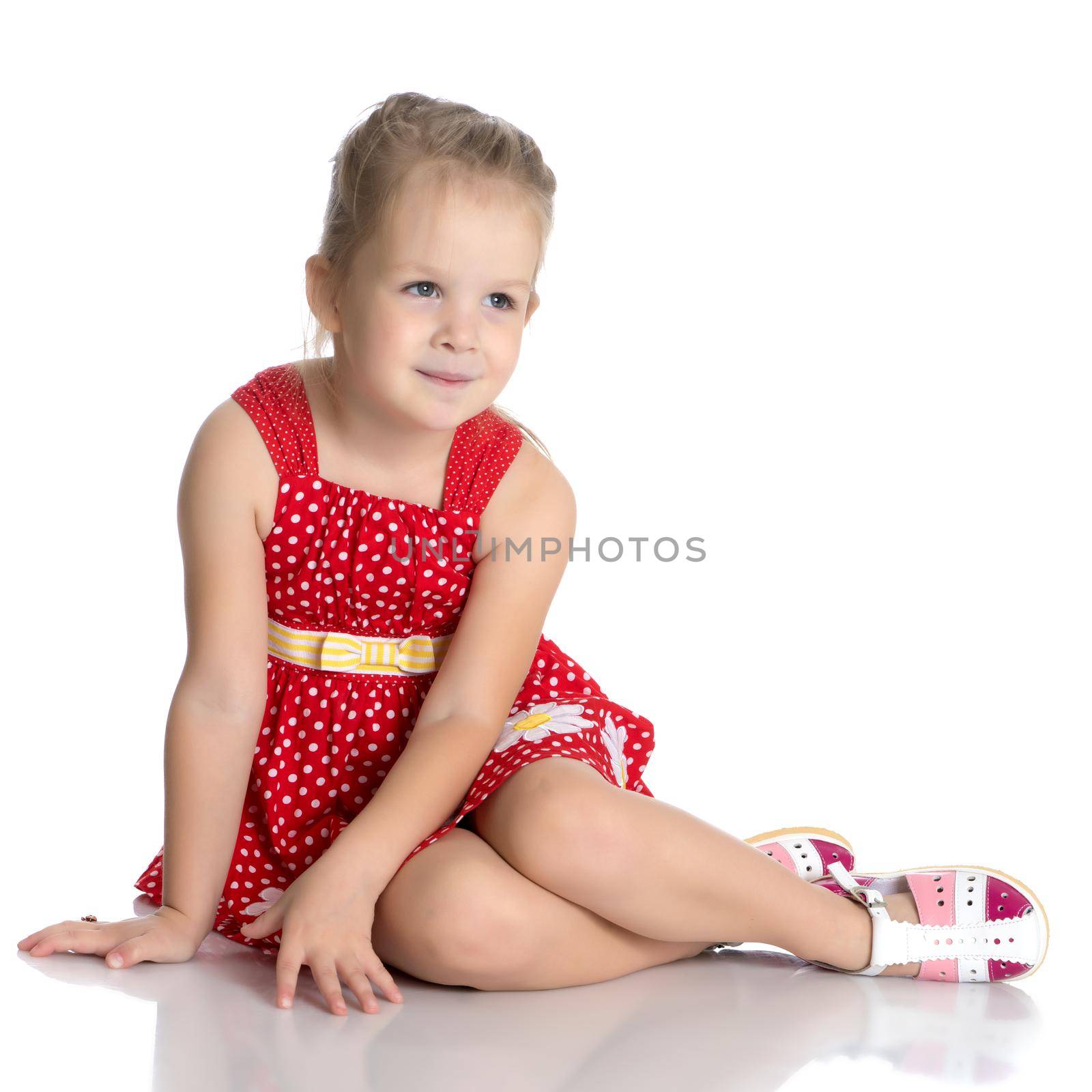 Fashionable little girl in a dress. Beauty and style in children's clothes. Isolated over white background