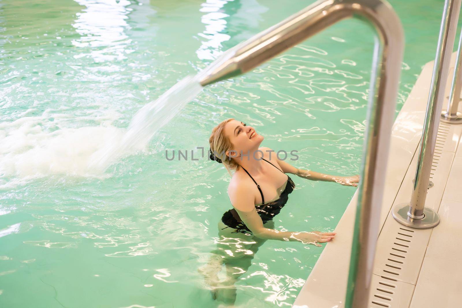 A portrait of a Happy beautiful woman enjoying time on the pool