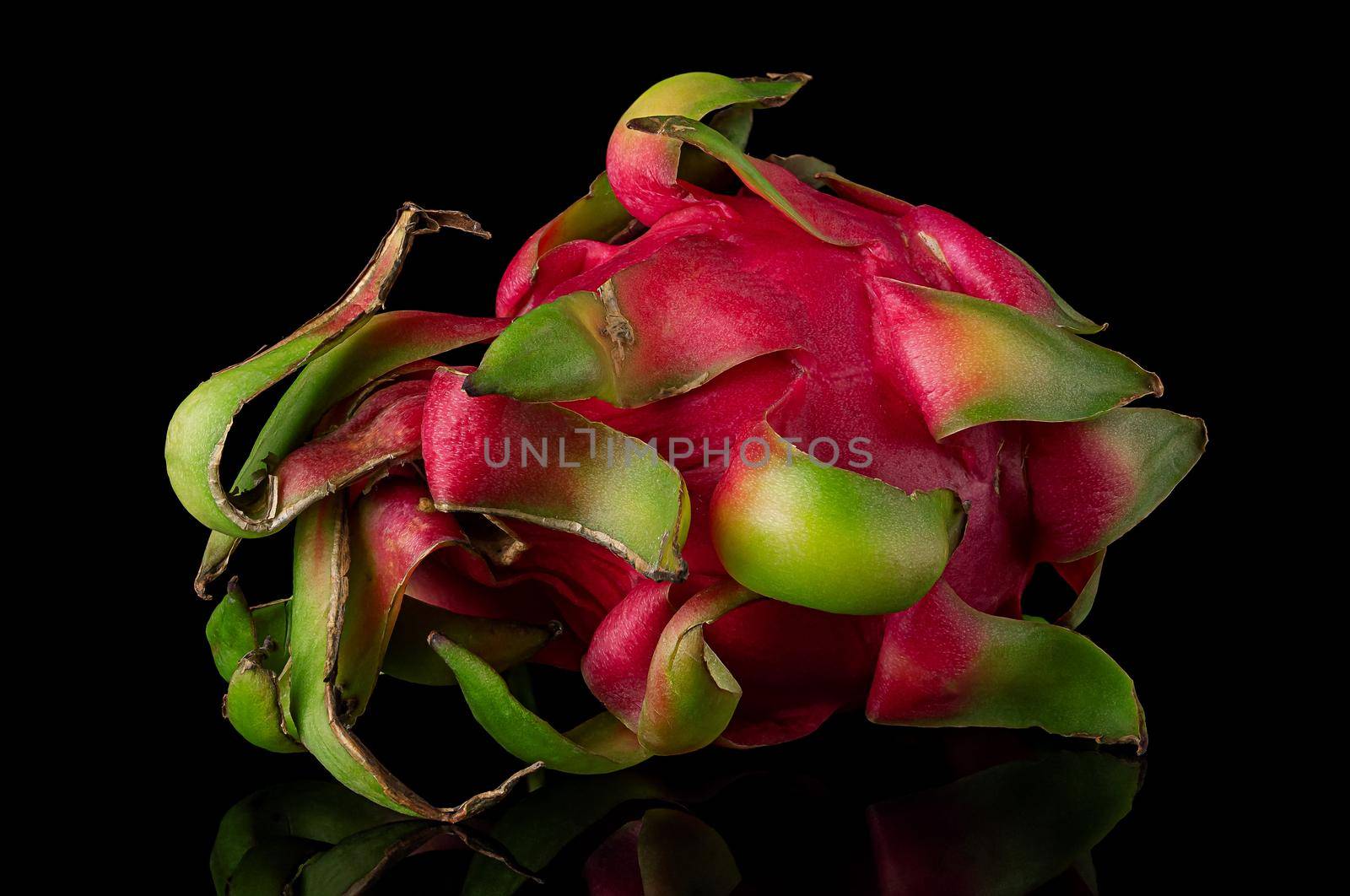 Dragon fruit horizontally rotated on a black background with reflection