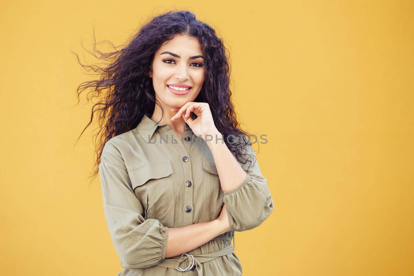 Young Arab Woman, model of fashion, with curly hair in urban background