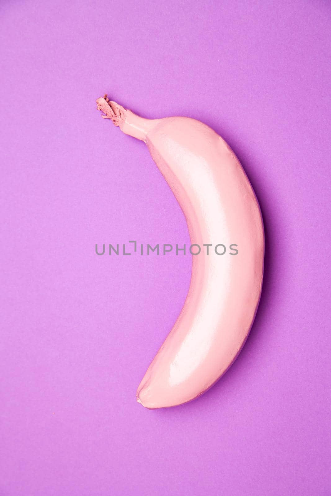 Top view of pink colored ripe fresh sweet banana placed on purple background