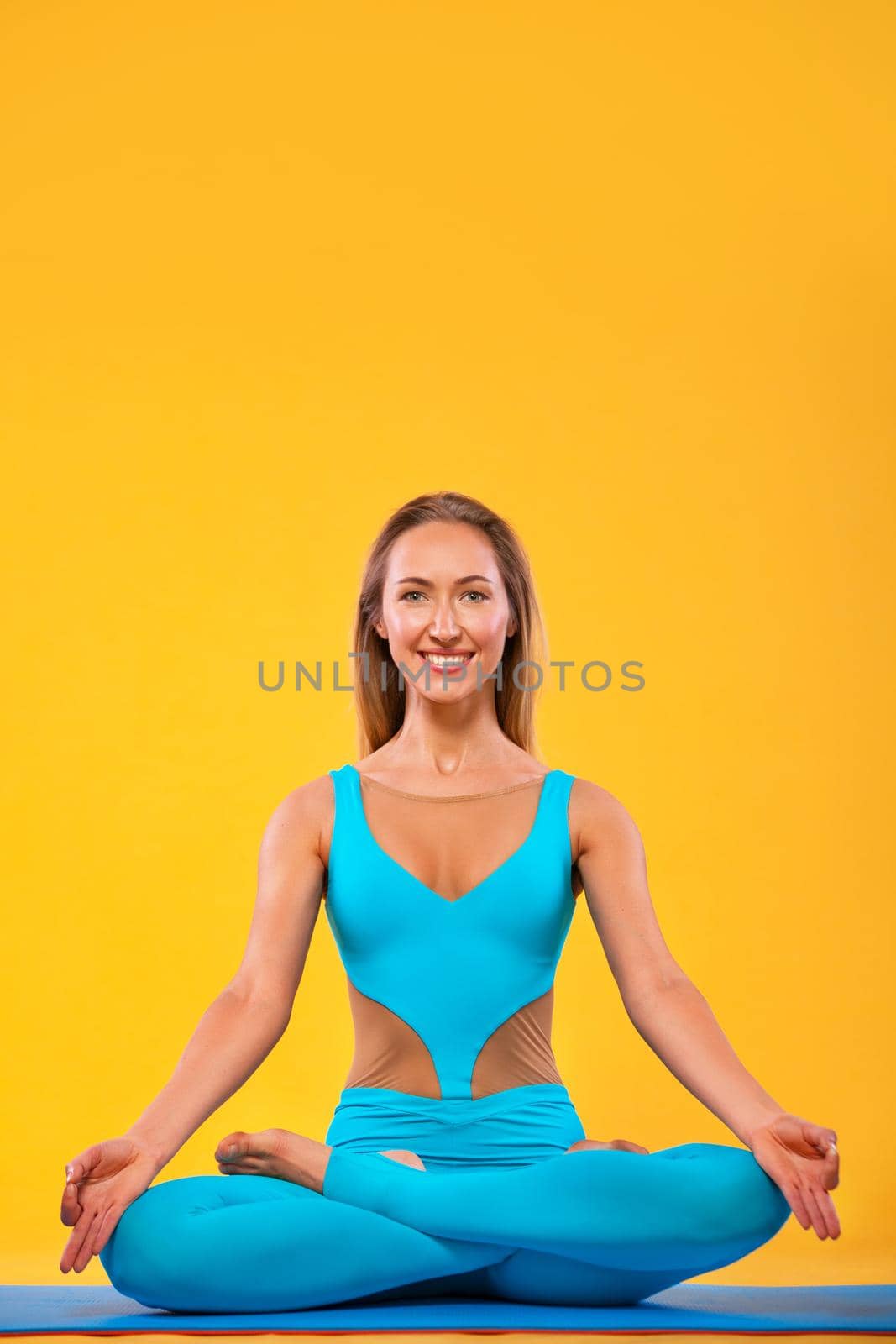 Yoga Indoor. Sports recreation. Beautiful young woman in hand mudra and namaste pose for meditation. Individual sports. by MikeOrlov