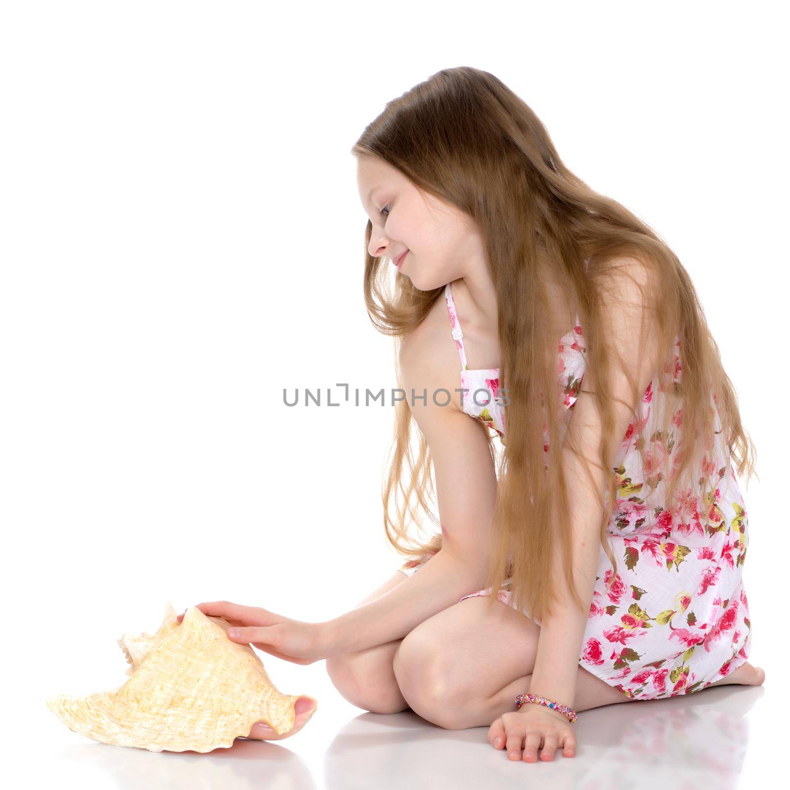 A little girl with a sea shell. The concept of a family vacation at sea, ecology. Isolated on white background.