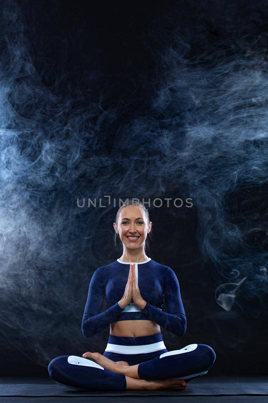 Yoga Indoor. Sports recreation. Beautiful young woman in hand mudra and namaste pose for meditation. Individual sports. by MikeOrlov