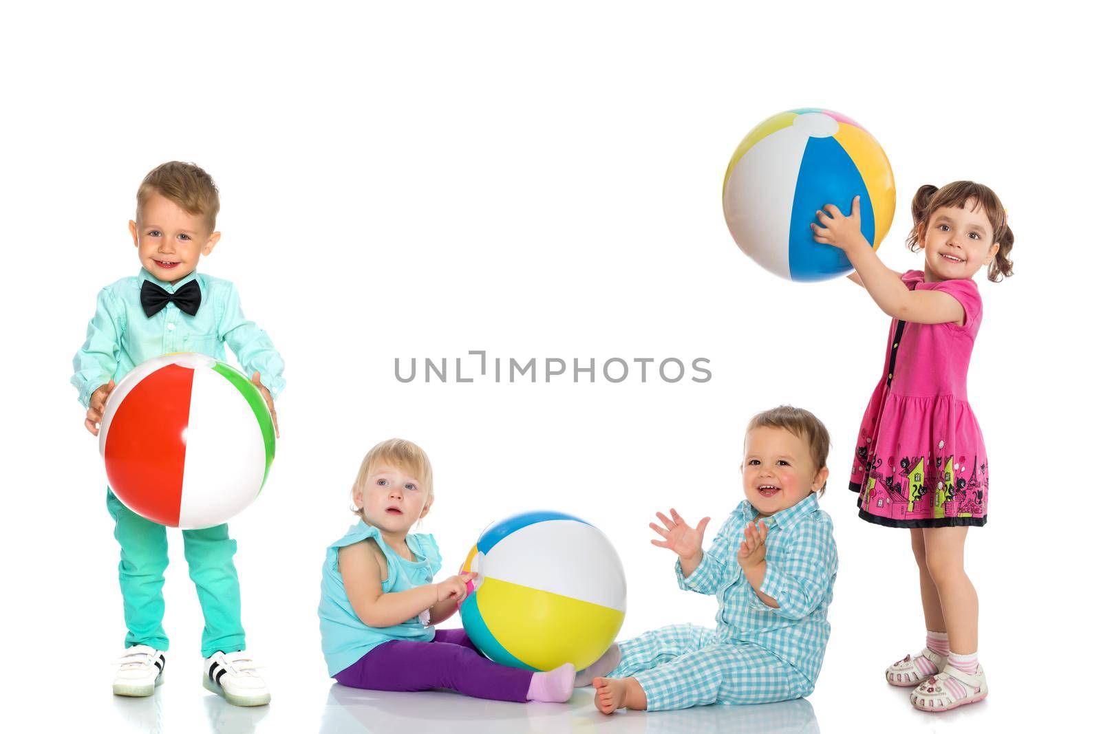 Cheerful children play with a ball. by kolesnikov_studio
