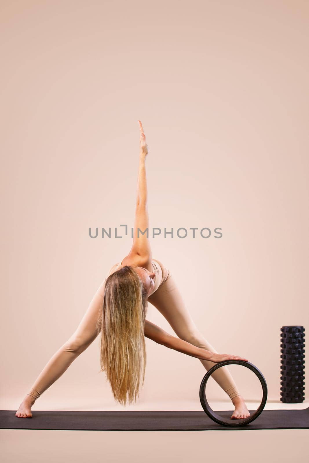 Indoor Yoga Classes. Sports recreation. Beautiful young woman in asana pose. Individual sports. Nude sportswear. by MikeOrlov