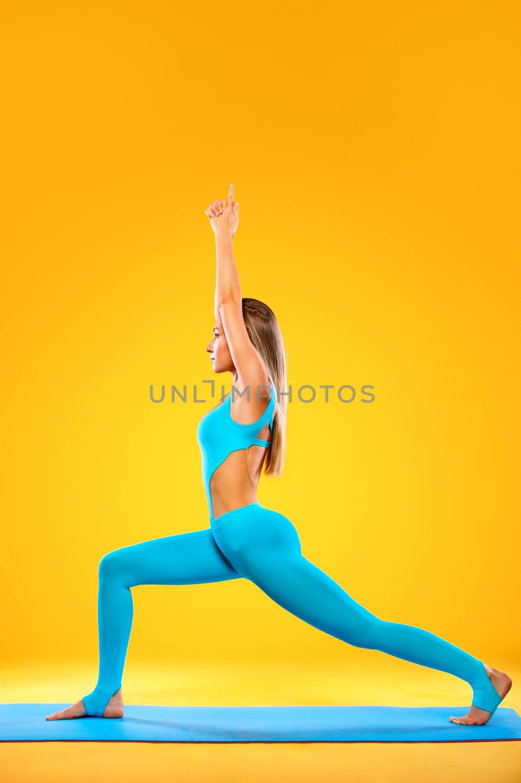 Portrait of a beautiful young woman sitting in yoga pose