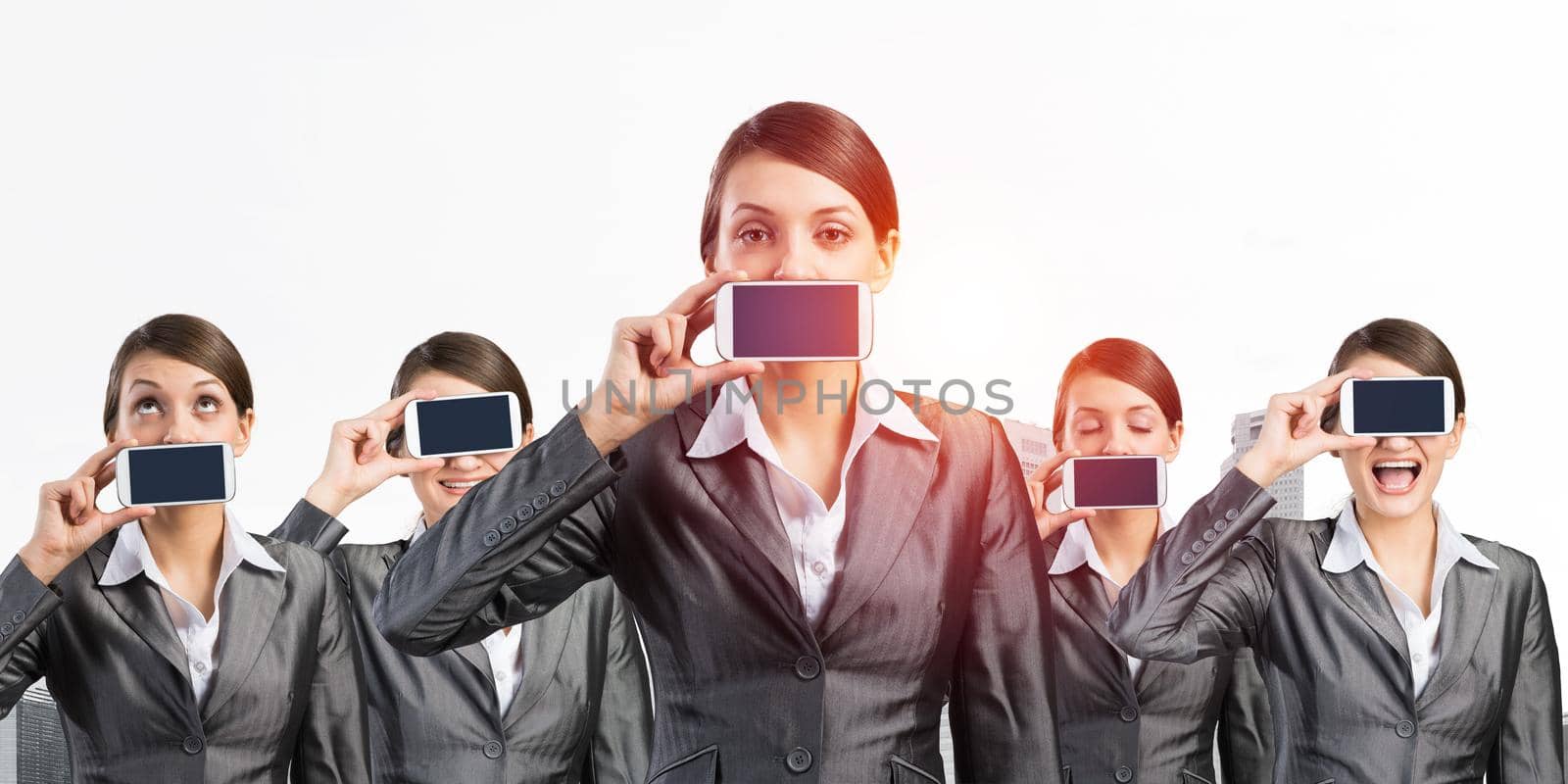 Business woman closes her mouth and eyes with a mobile phone. Business concept