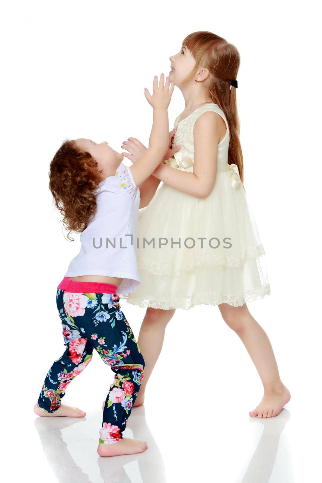 two sisters play fun playing. The concept of family happiness and development of children. Isolated over white background